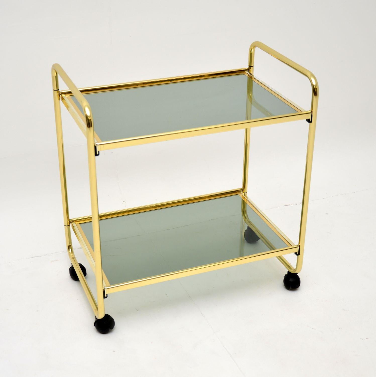 A wonderful vintage Italian drinks trolley in brass, with a very clever folding design. This was made in Italy by MB Italia, it dates from around the 1970-1980’s.

The quality is fantastic, and this has an unusual patented method of folding