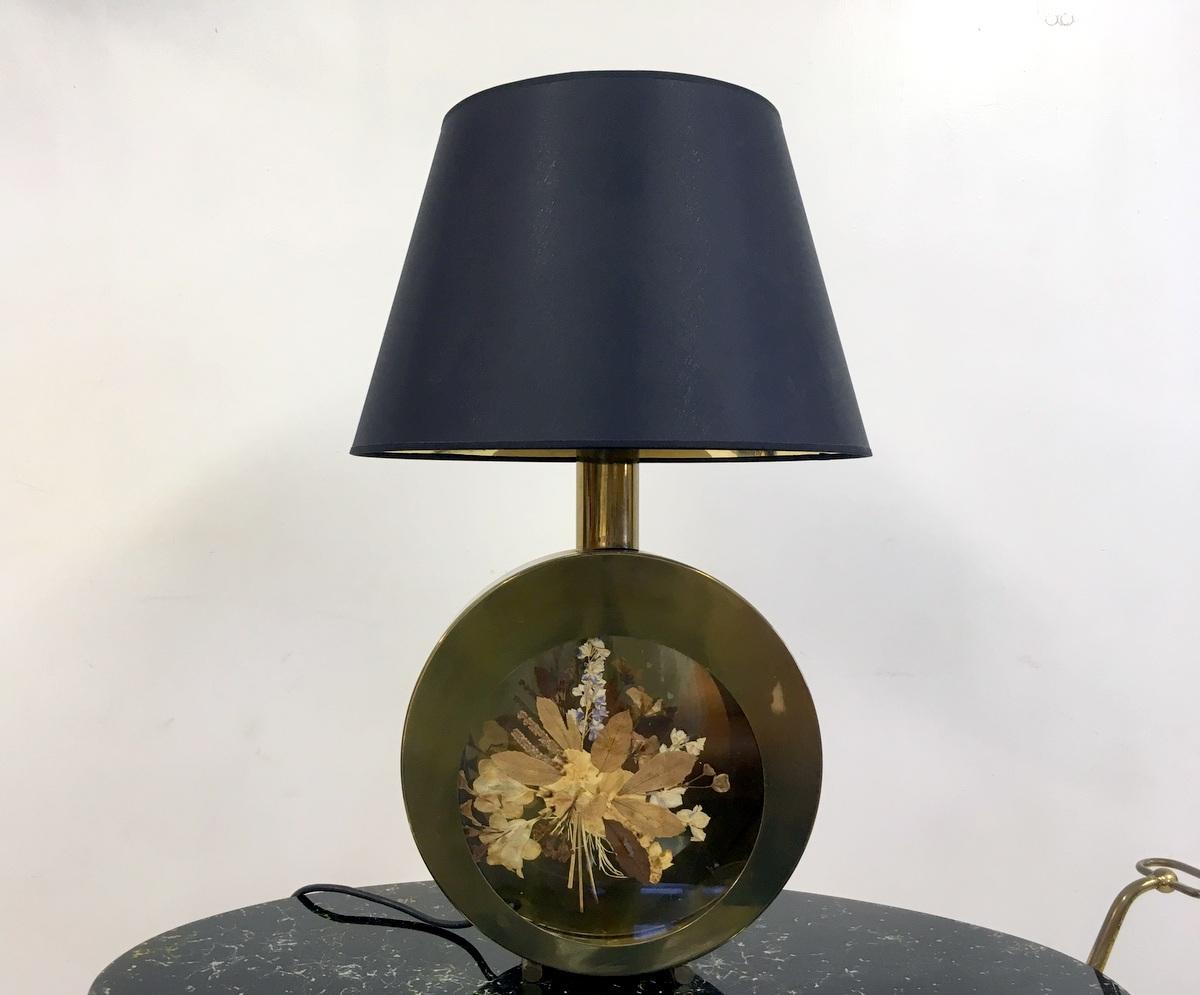 Circular table lamp
Brass rim
Glass centre with pressed flowers inside 
New black shade with gold reflective interior
Italy 1970s.