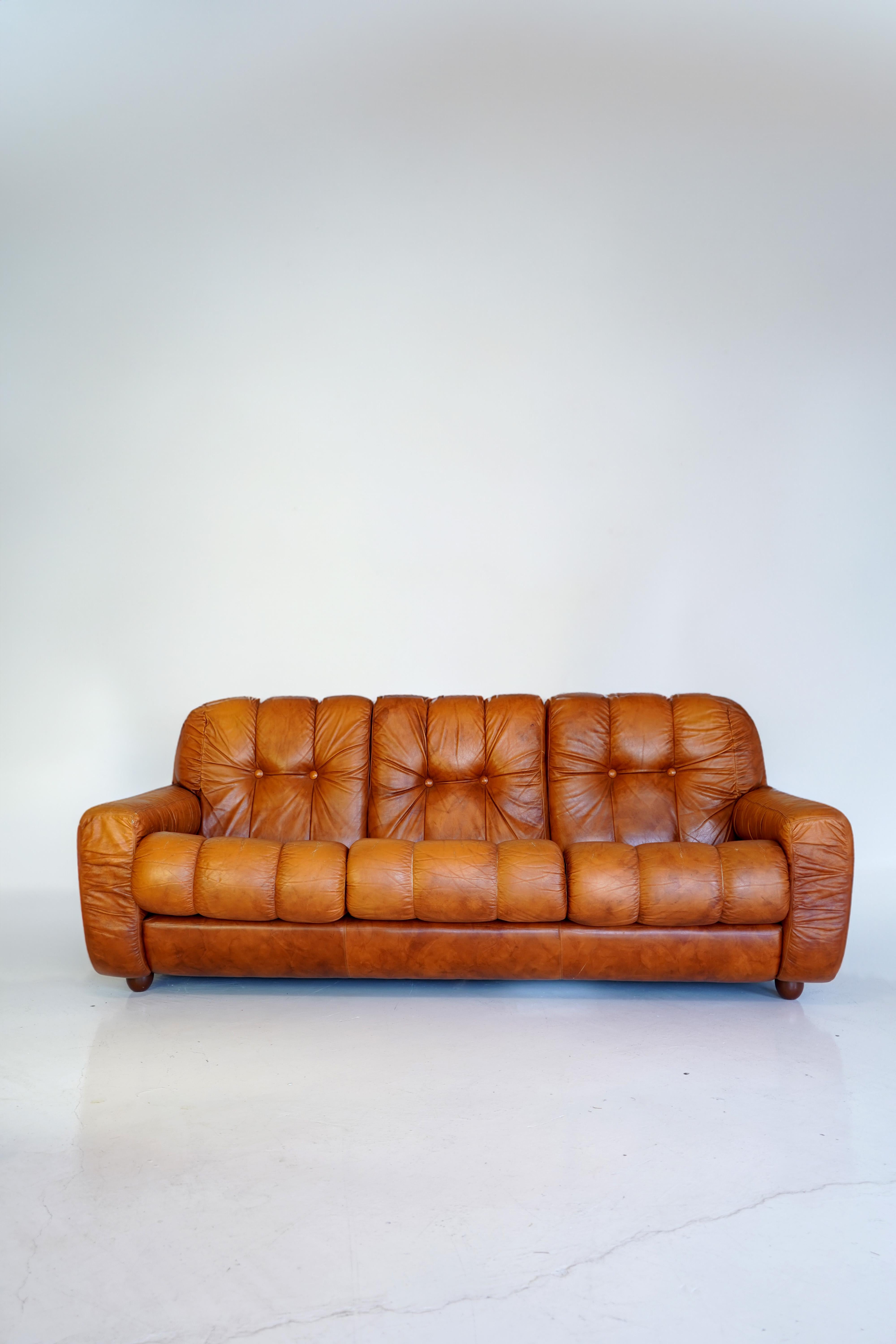 Classic 70s vibes with this Italian leather sofa with vinyl frame. In the style of sofa designs by De Sede. Matching armchairs also available.

Wear in 2 spots on back edges of the frame however the rest of the sofa is in very good condition.