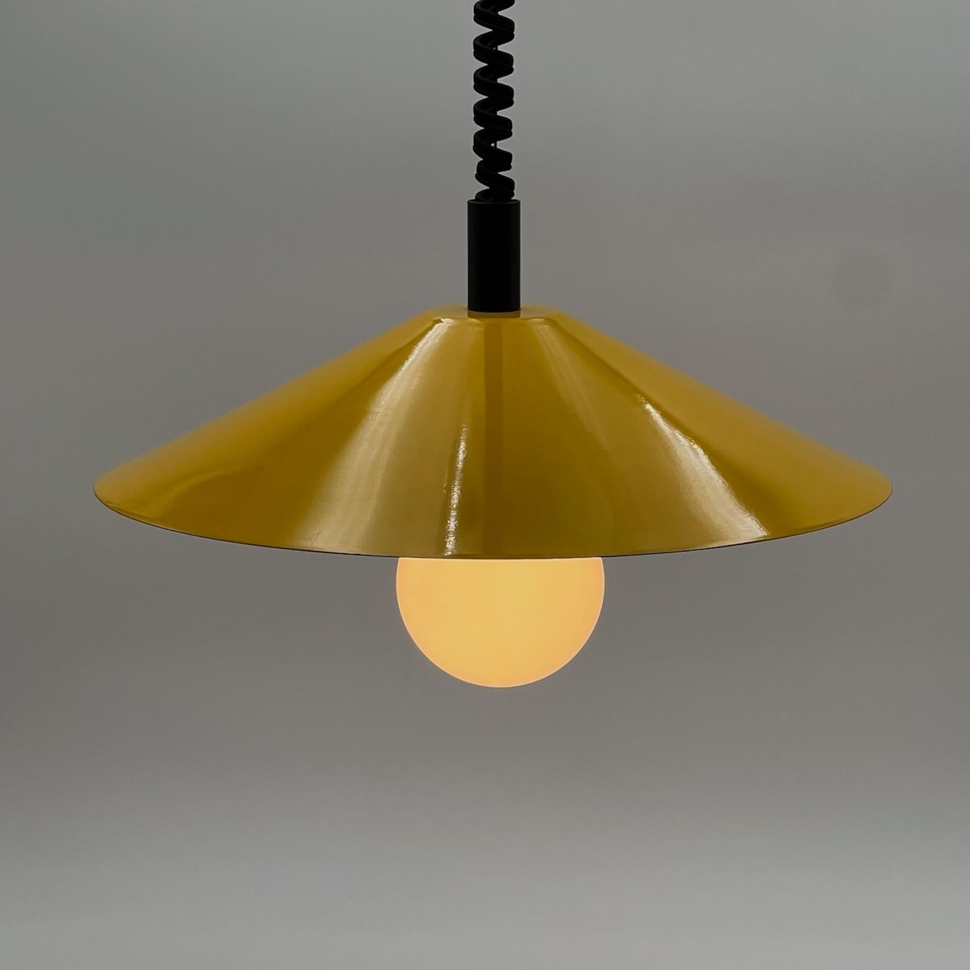 Step into the captivating world of vintage design with this space age hanging lamp, a remarkable piece crafted in Italy during the 1970s. The lamp exudes a minimalistic charm, featuring a cone-shaped lampshade made of lacquered metal that is