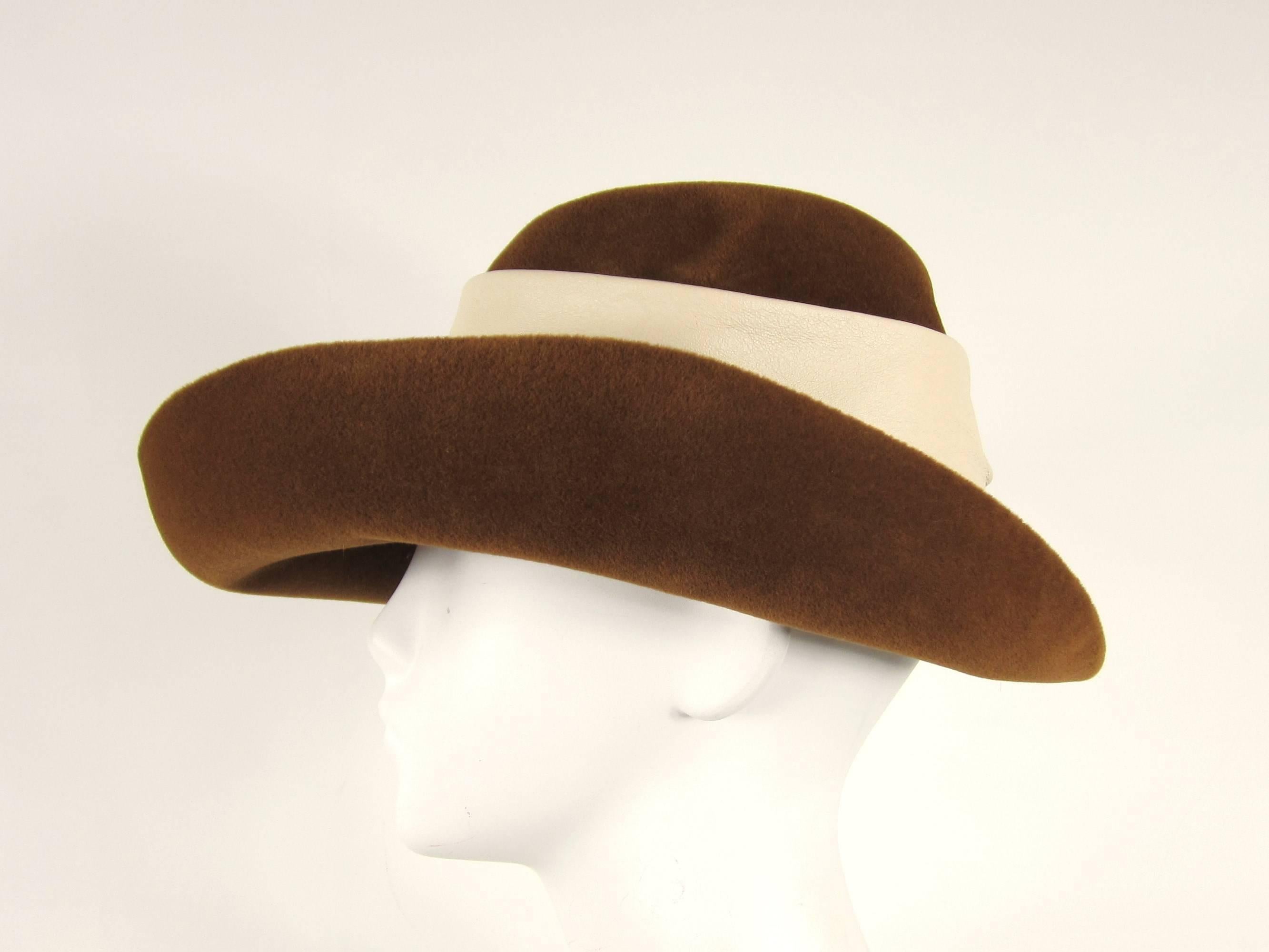 Stunning wide brim hat with large Bow at the side. Measuring 23.5 inches around inside of hat. Approx. 7-3/8. Brim is 4.25 in at the widest 
Please check our storefront for hundreds of items including New, Never worn vintage Jewelry as well as more