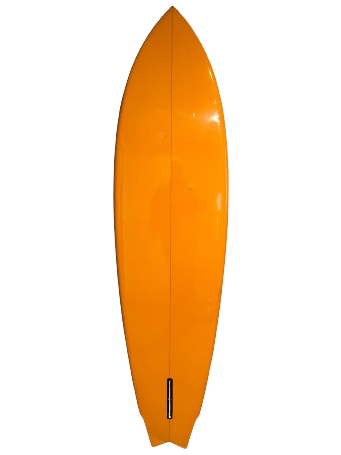 Mid-1970s Lightning Bolt Gerry Lopez model surfboard. Features beautiful orange tint and bright yellow lightning bolt. Unique V swallow tail. A remarkable example of an all original 1970s Gerry Lopez model Lightning Bolt surfboard to ride or