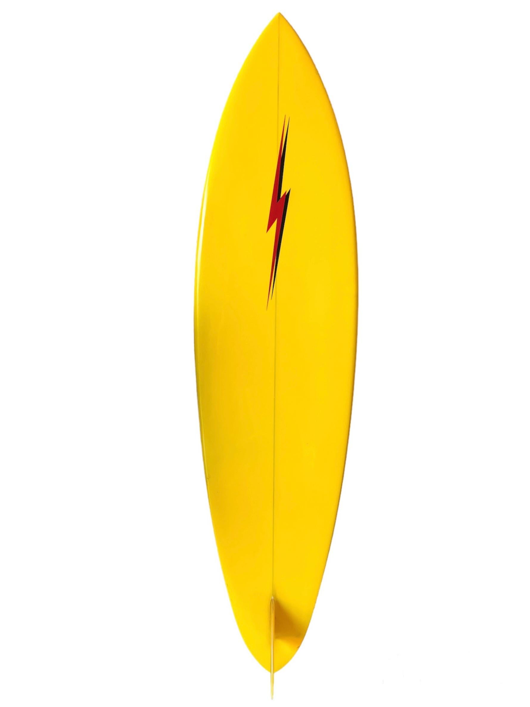 Mid-1970s vintage Lightning Bolt surfboard made by Tom Parrish. Features bright yellow tint with double rail lightning bolt pinstripes. Beautiful red lightning bolt design with complimentary black shadow. A remarkable example of highly coveted 1970s