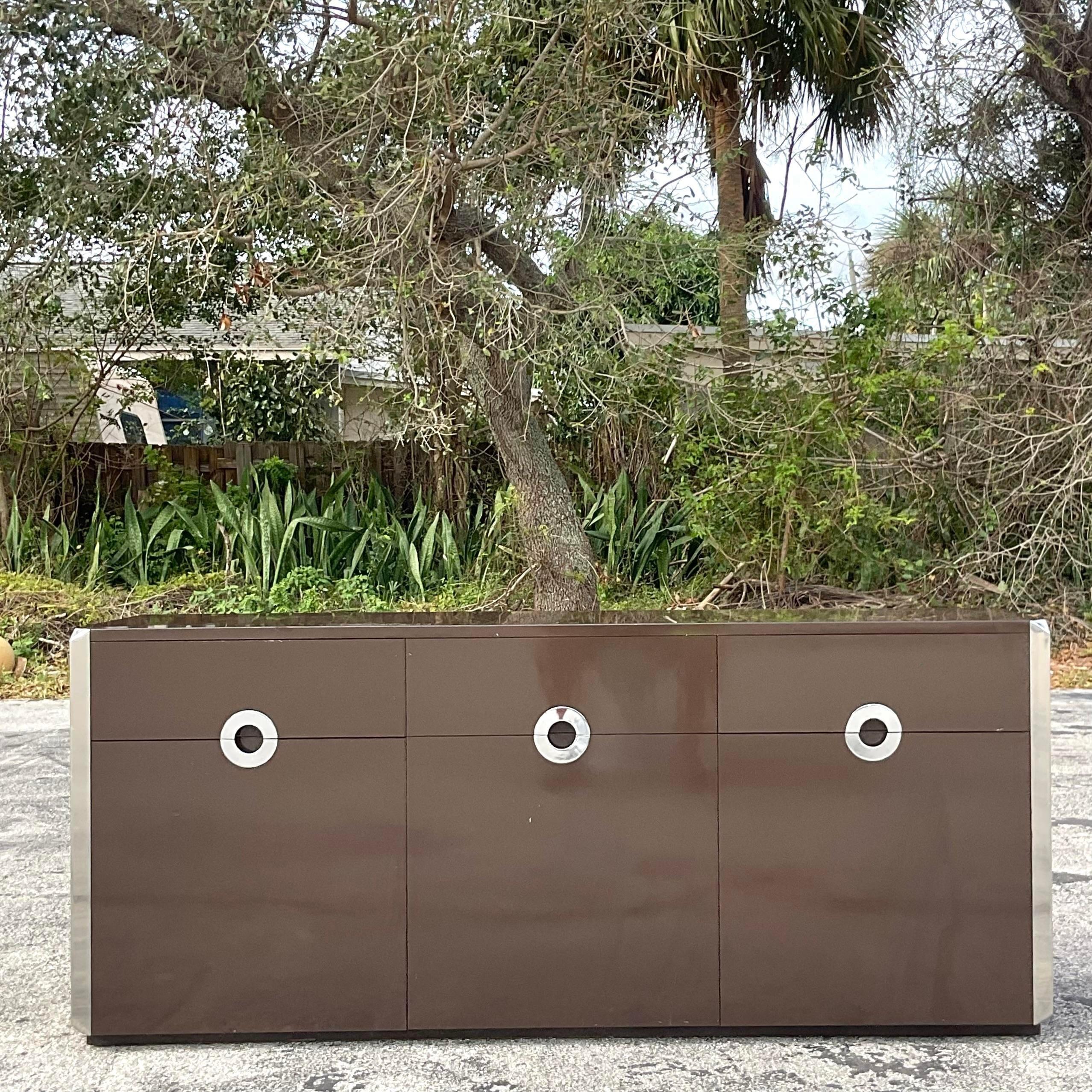A fabulous vintage Contemporary sideboard. A 1970s gem by thr Italian designer Mario Sabot. Beautiful chocolate melamine wood in a rich Chocolate brown. Gorgeous chrome trim. Acquired from a Palm Beach estate