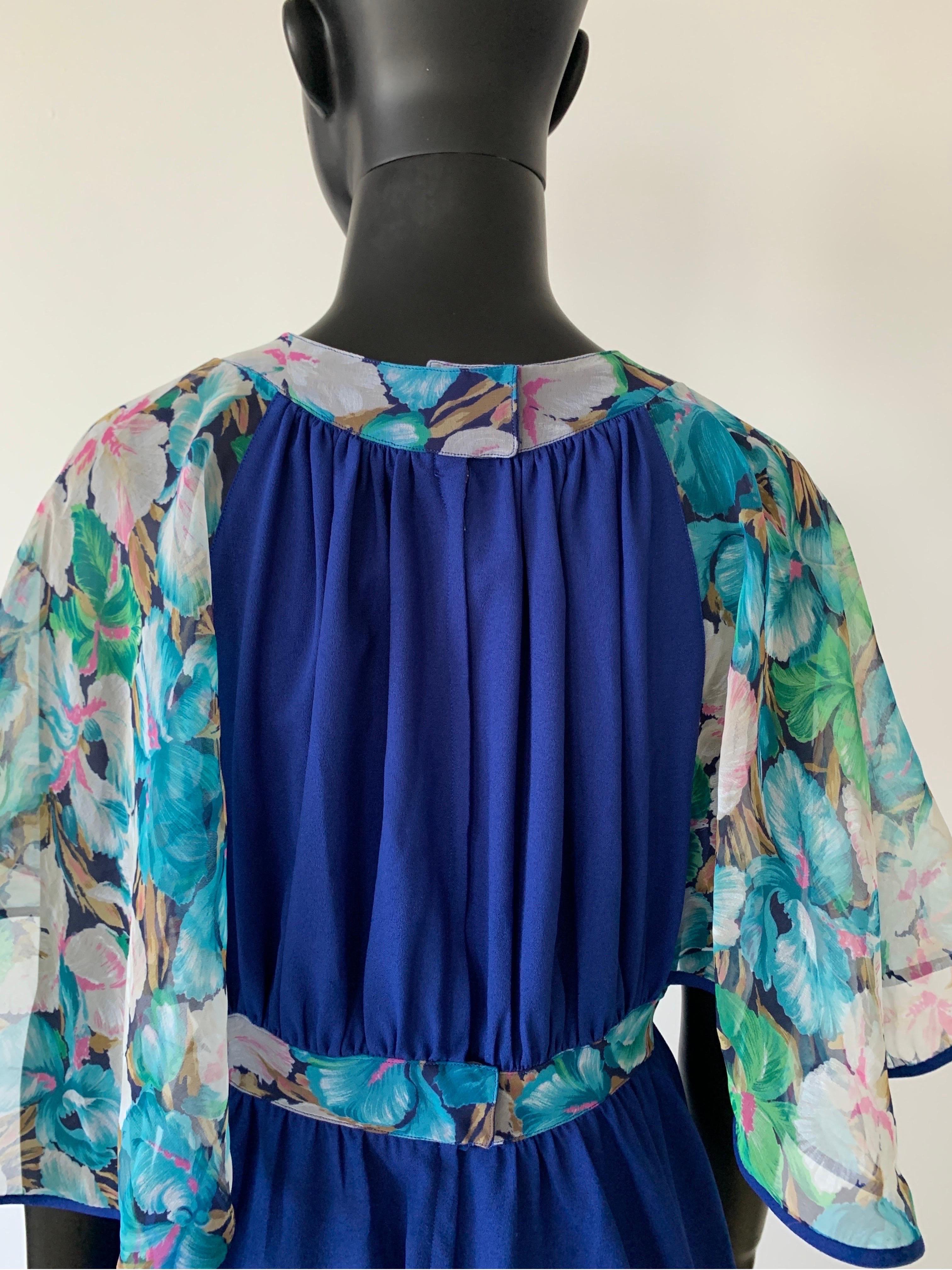 A super 1970’s vintage long dress in fantastic cobalt blue colour with chiffon floral Angel  sleeves and waist detail. 

The perfect spring/summer dress for that garden party or a fun dress for a resort.

A great example of this era of fashion.

In