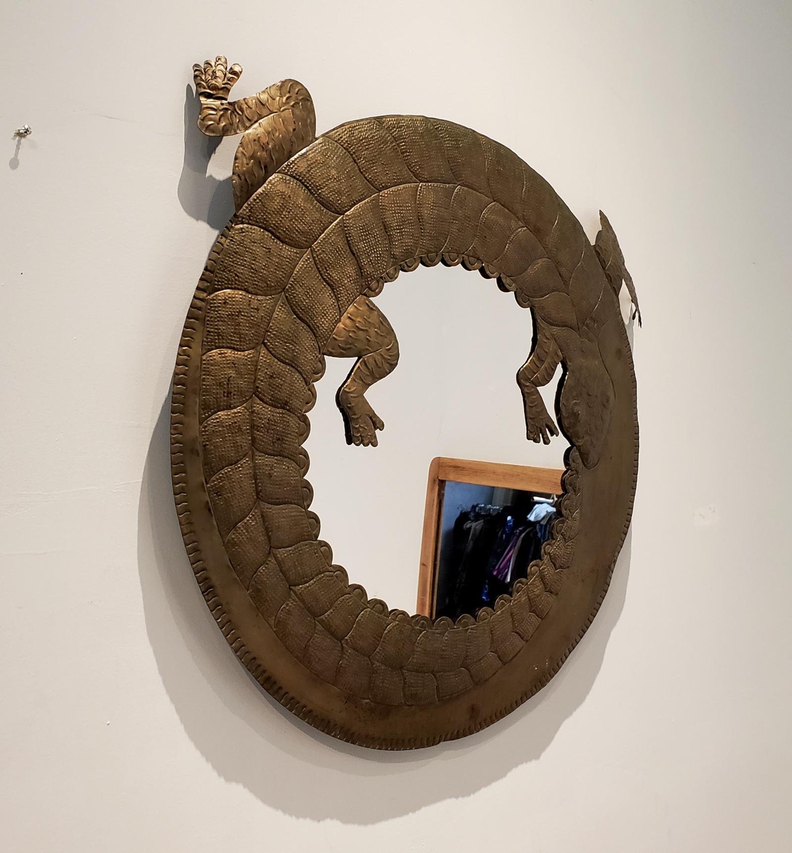 Charming and unique circular mirror with coiled lizard framed. Handmade in Mexico of hammered and cut brass, circa 1970s. The mirror measures: 27.5