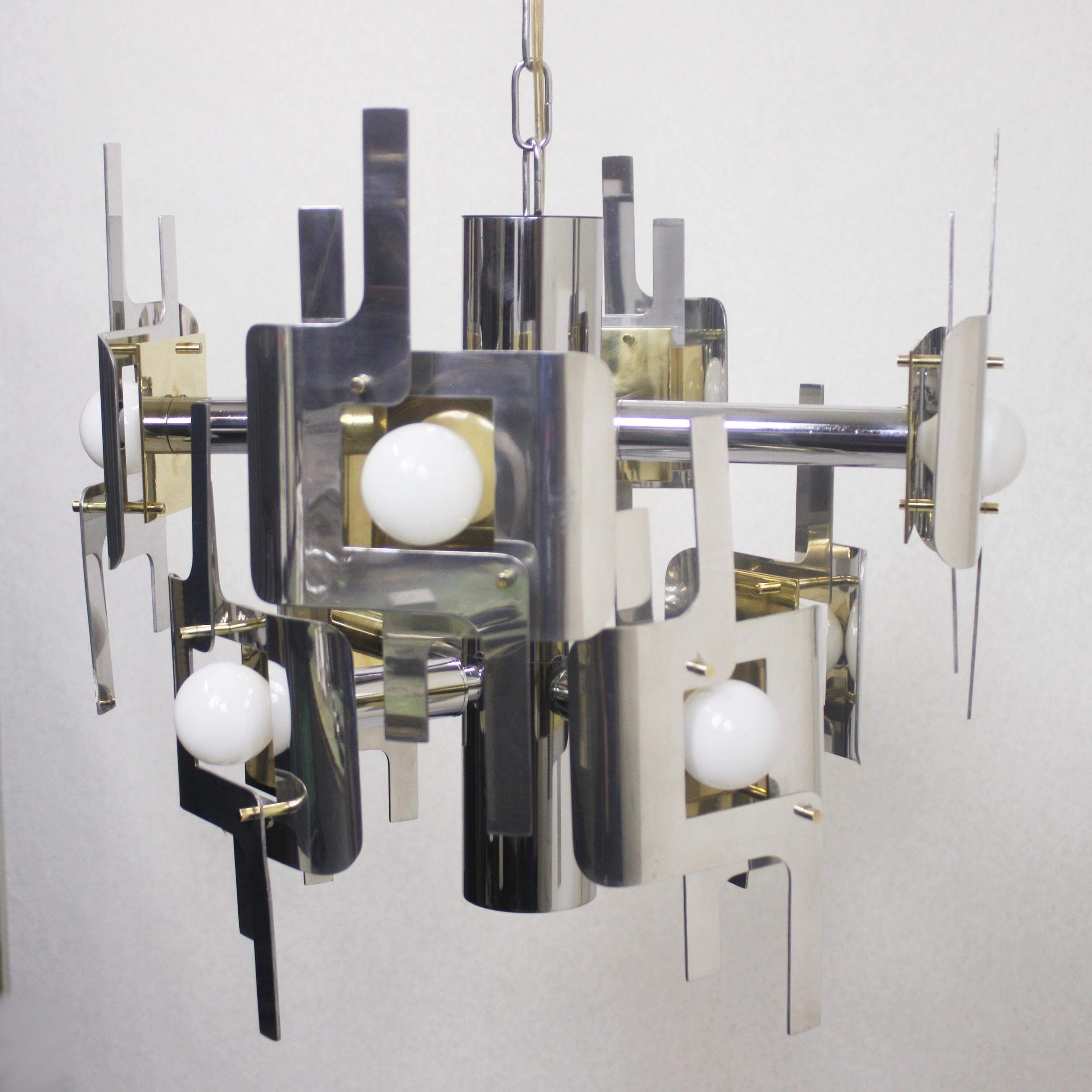 Gorgeous sculptured chandelier designed by Gaetano Sciolari for Lightolier. This is the rare sculpture design crafted like a piece of fine jewelry from over 120 individual, brass, chrome and aluminium pieces! Light fixture has been completely