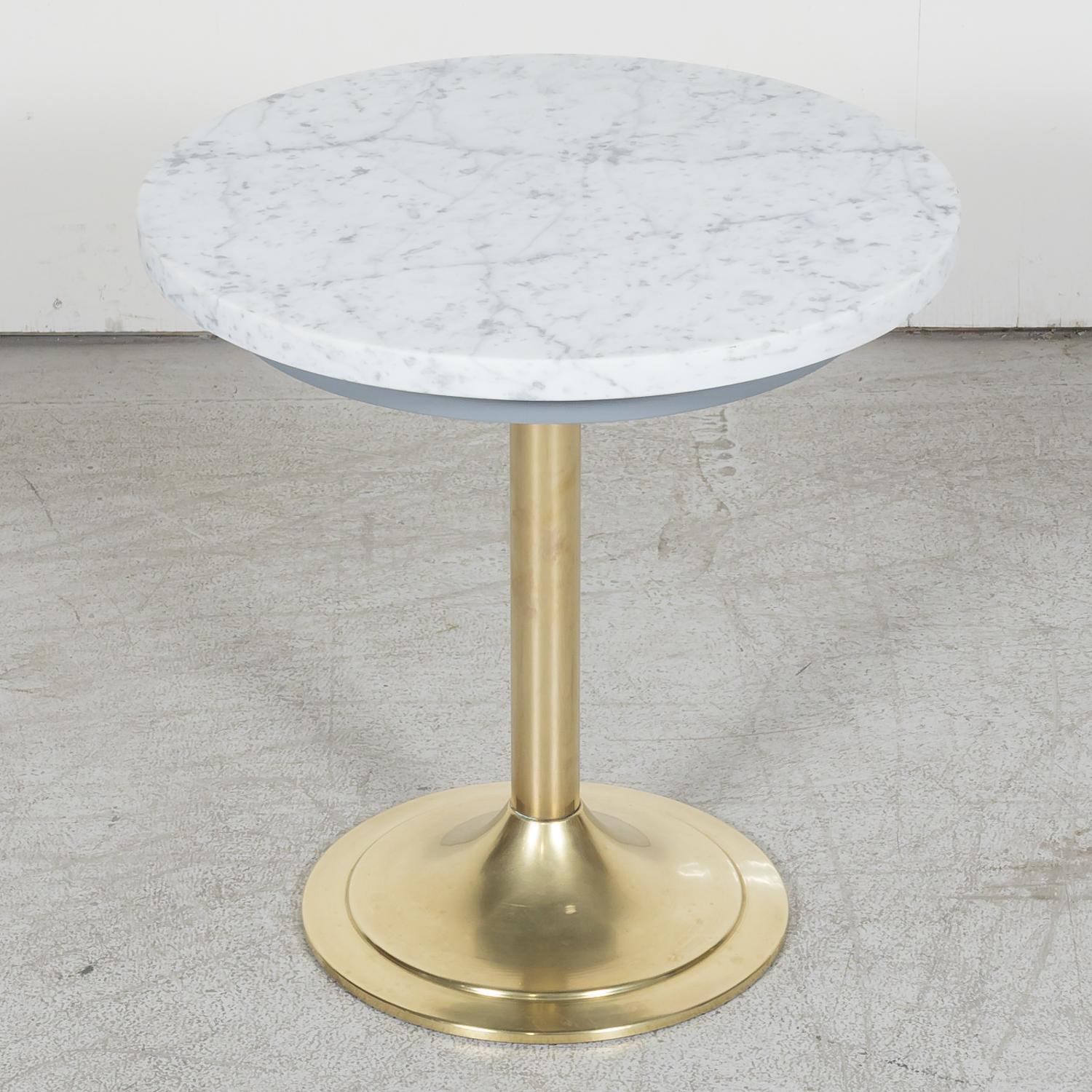 Fabulous vintage mid-century modern French cocktail tables from a casino in Deauville, France, circa 1970s, having a solid, heavy brass trumpet base and round Cararra marble top. Three still available. Price is for a single table.
Dimensions:
h -