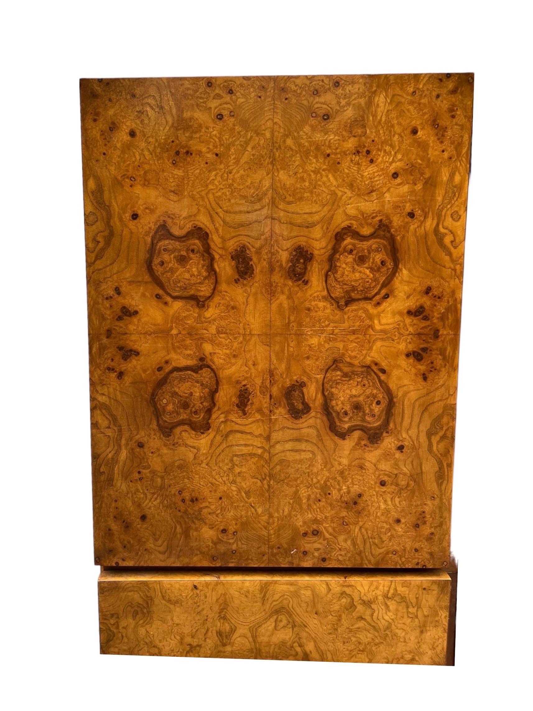 A highboy or gentleman's chest by Lane Furniture by manner of Milo Baughman. Gorgeous book matched olive burl wood veneers. Ample storage including 4 deep drawers and cabinet.

Dimensions. 42