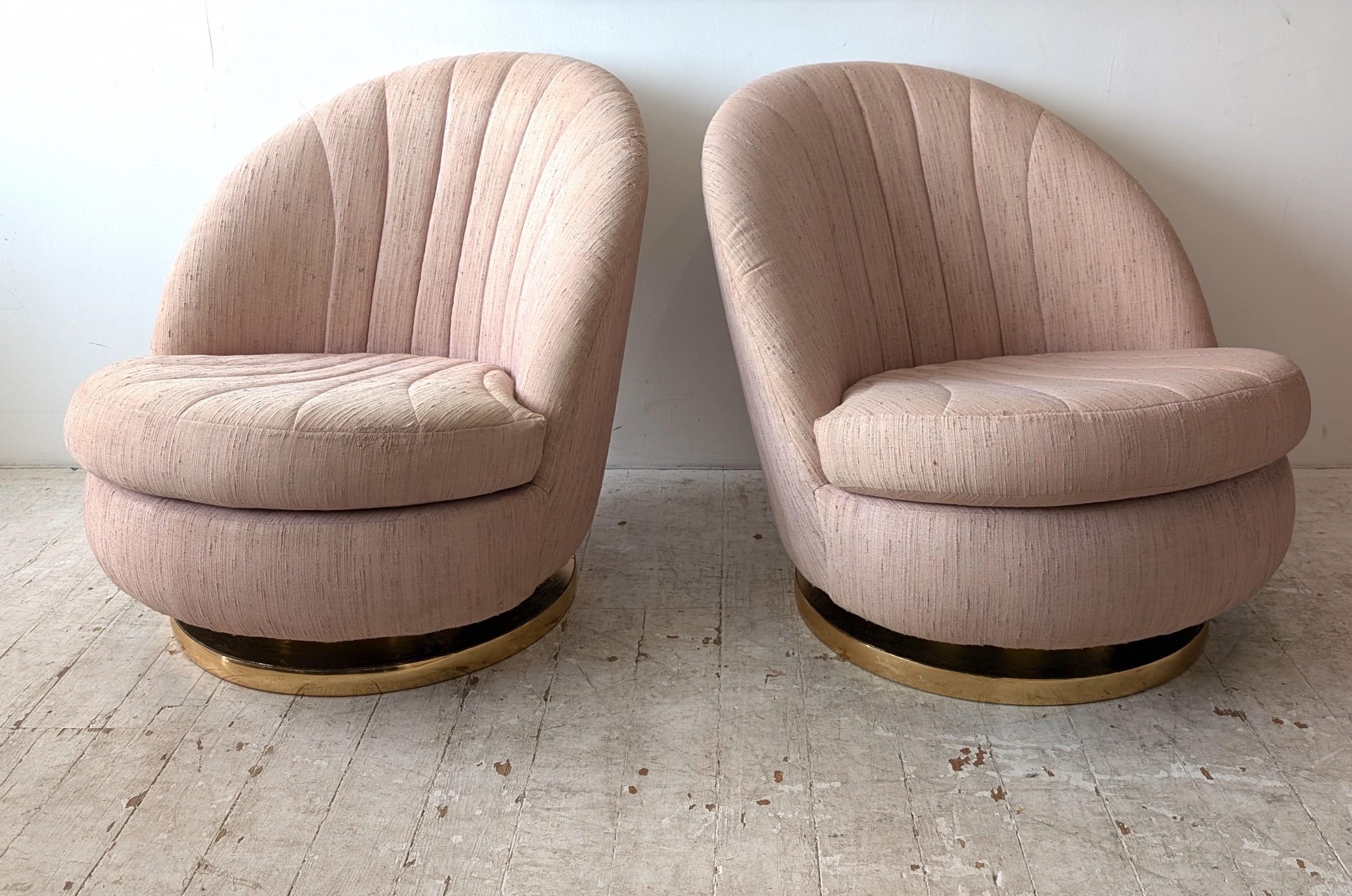 Clamshell lounge chairs designed By Milo Baughman for Thayer Coggin, circa 1970s. We have a pair of these- the price is per chair.
The chairs have a swivel and tilt action, making them extremely comfortable (and fun!) Circular gold metal base, pale