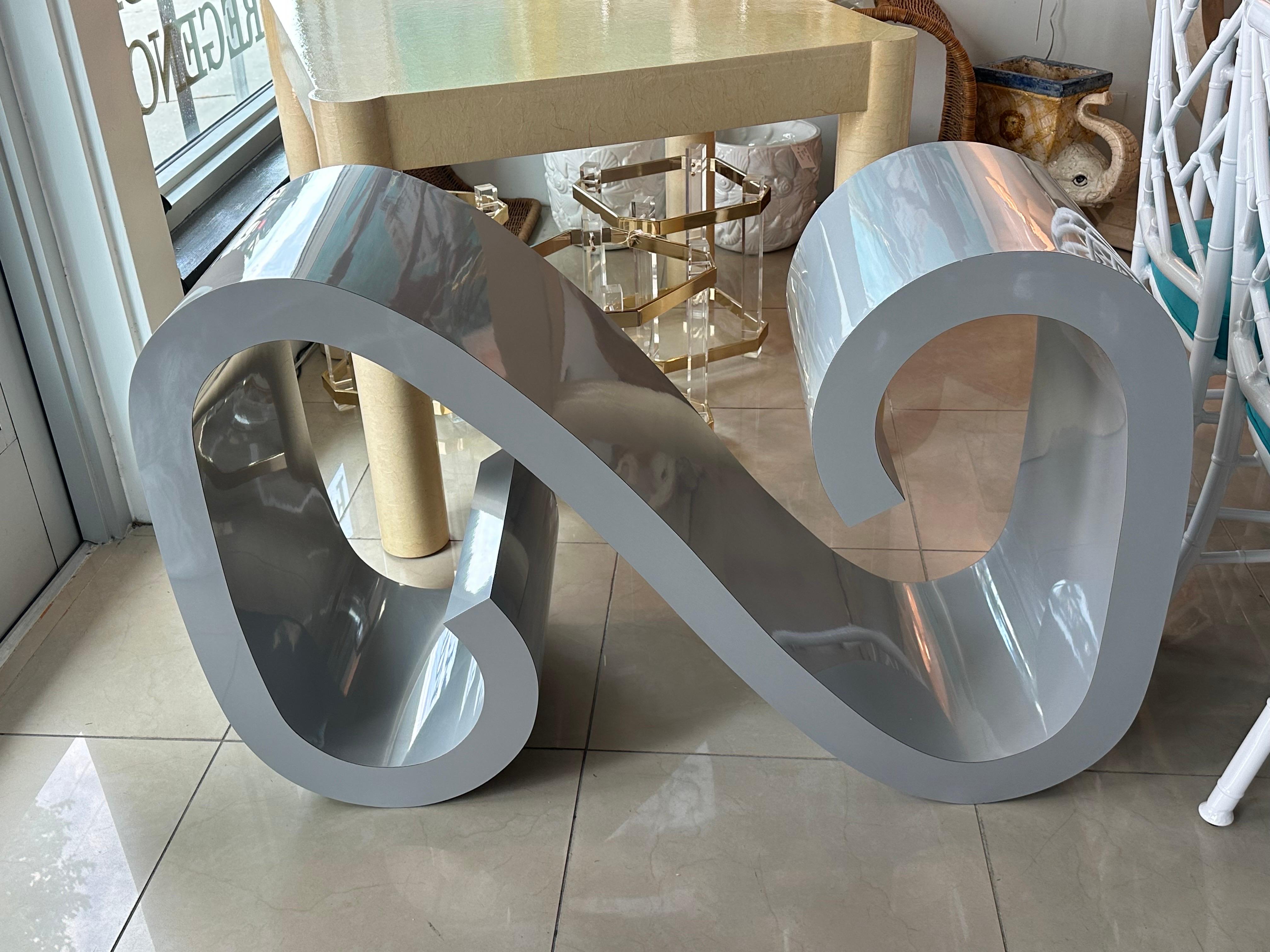 Vintage gray wave, scroll, ming console table. Such a great organic shape! Original laminate finish which overall is in great shape. Only thing I could see was 2 tiny chips on the back bottom, shown in pics. Very hard to see. Ready for your glass,