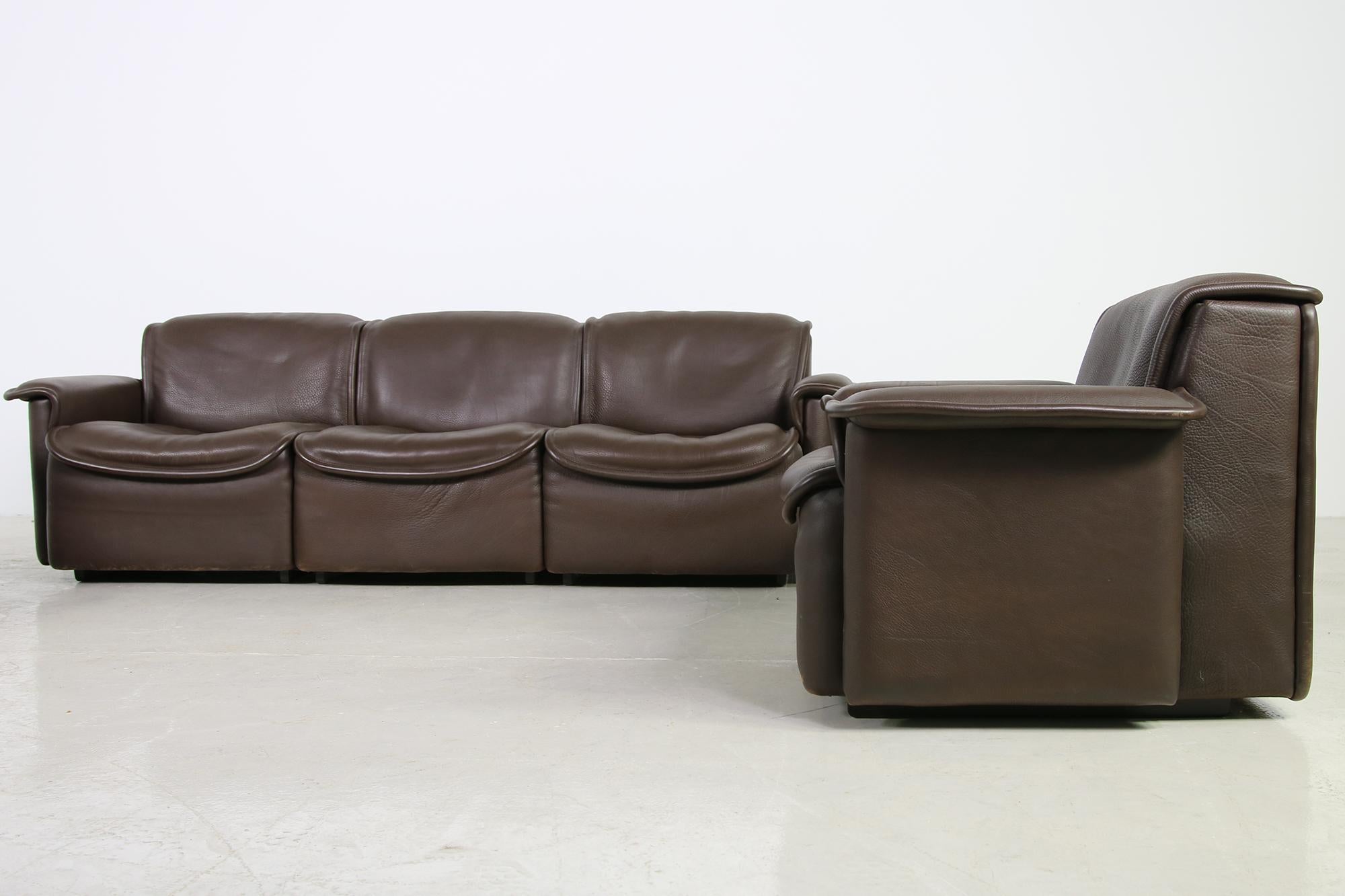 A rare and beautiful set, manufactured in the 1970s by De Sede Switzerland, Mod. DS 12 a three-seat and a matching two seat sofa with a matching chair, a fantastic condition, beautiful dark brown leather, authentic 1970s object in very good vintage