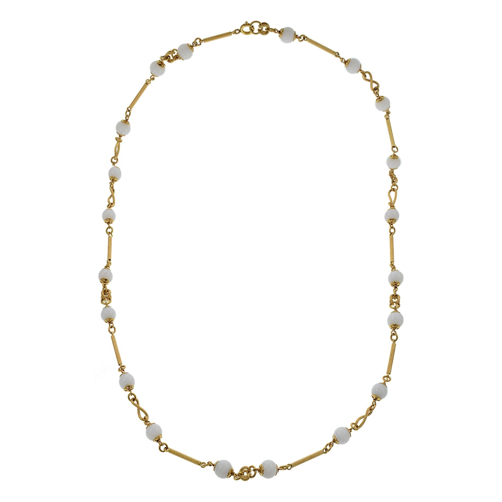 This vintage necklace from the 1970s features beautiful mother of pearl (MOP) beads, elegantly strung along a 32-inch length. The design is enhanced with 18KT yellow gold tubes and rope accents, adding a touch of luxury and sophistication. This