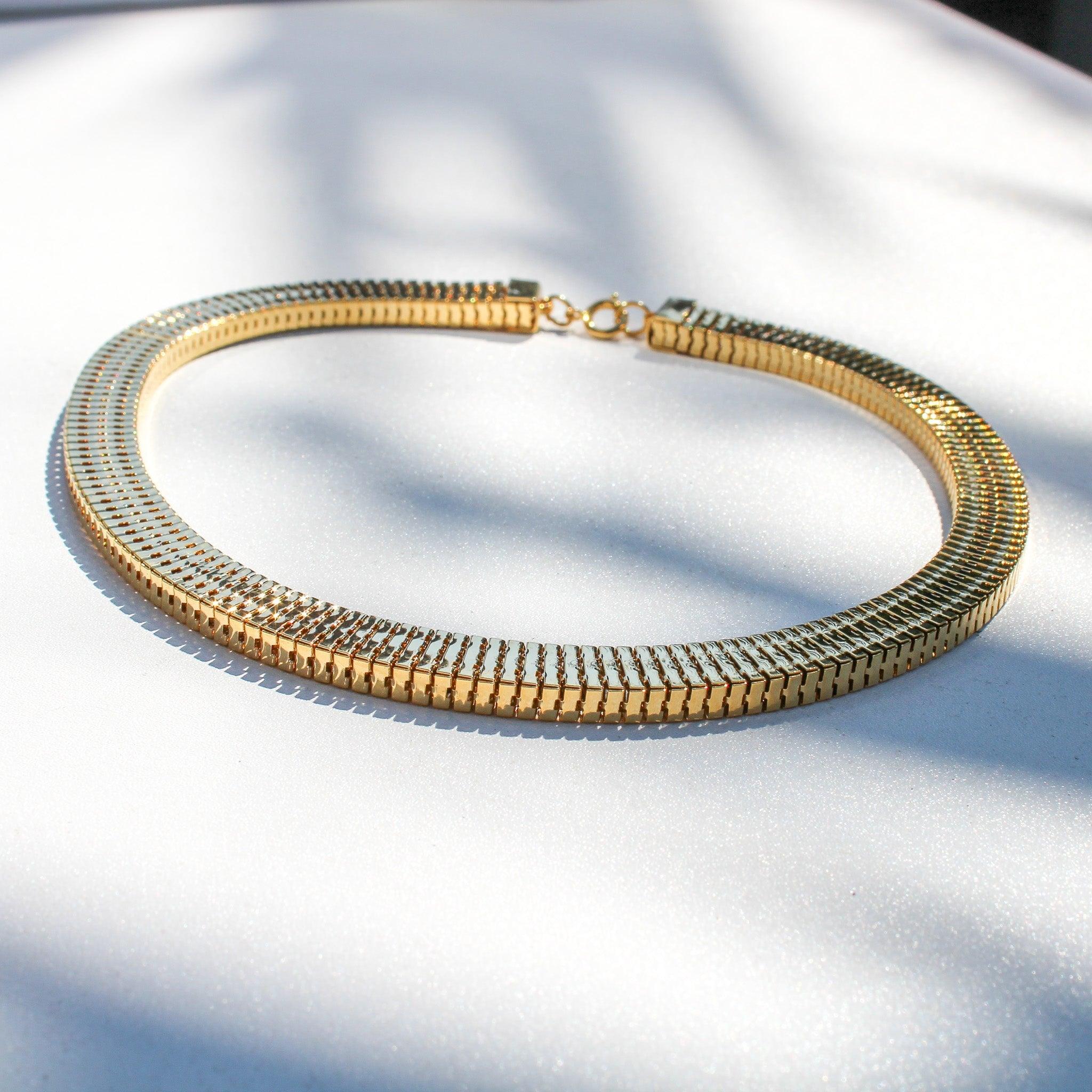 
Vintage 1970s Necklace - 18 Carat Gold Plated Deadstock
 

Step into a time machine of style with this throwback to the disco era. This effortless 1970s gold-plated choker necklace is the perfect blend of vintage and contemporary style.

Clad in an