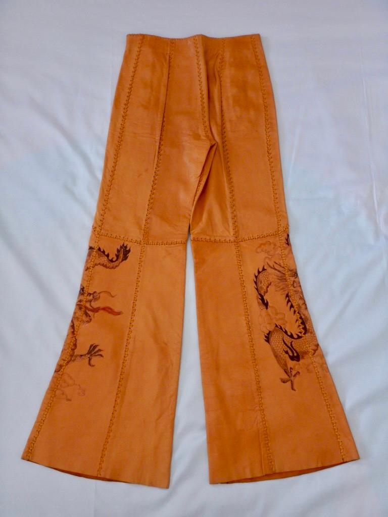 Vintage 1970s handmade North Beach Leather deerskin pants in a sailor-pant style, flared bell bottom fit. Whipstitch construction, 8-button front. Dragon art on both legs, signed 