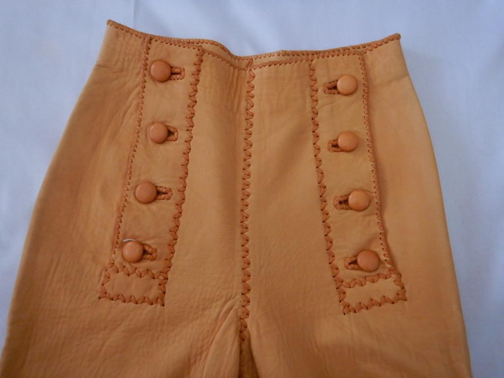 Vintage 1970s handmade North Beach Leather deerskin pants in a sailor-pant style. Whipstitch construction, 8-button front.

These are in good condition, especially for a pair of this age from North Beach Leather. The leather is incredibly soft and
