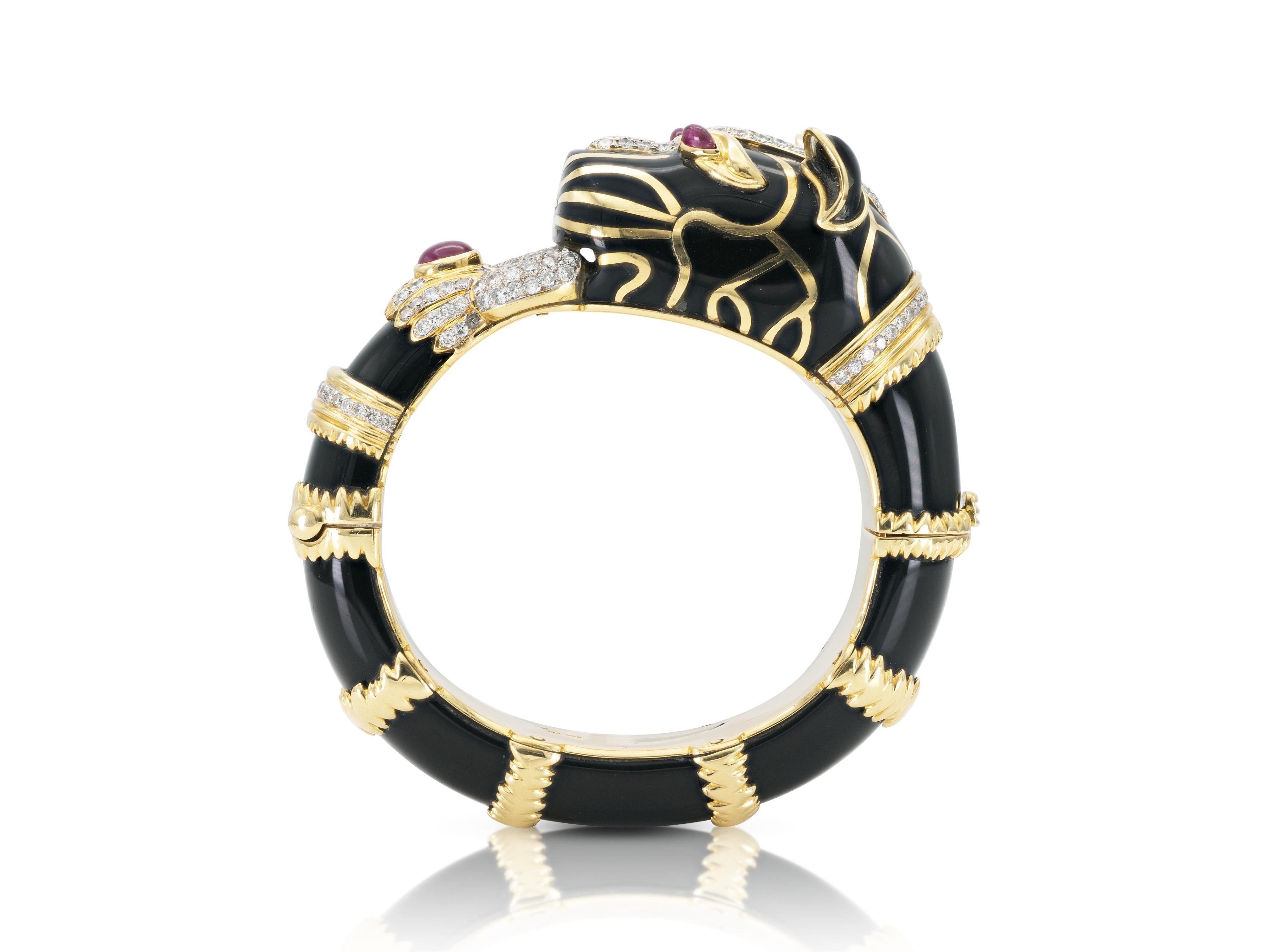 Finely crafted in 18k yellow gold with Onyx, Round Brilliant cut Diamonds and Cabochon Rubies.
Circa 1970s
Size 6 inches