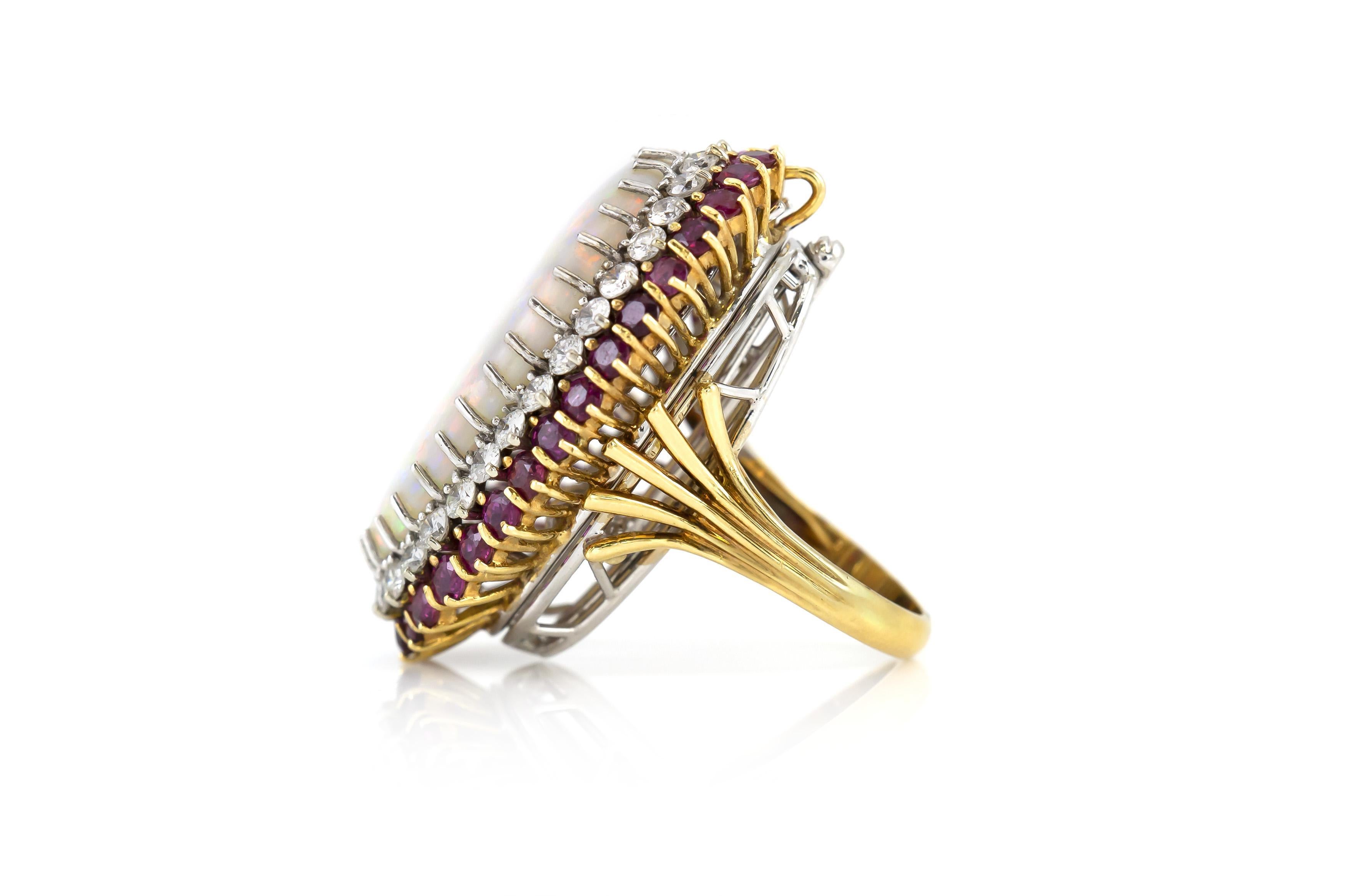 Finely crafted in 18k white and yellow gold with an Opal center stone surrounded by Round cut Rubies weighing approximately a total of 6.00 carats and Round Brilliant cut Diamonds weighing approximately total of 2.80 carats.
Circa 1970s
Size 6,