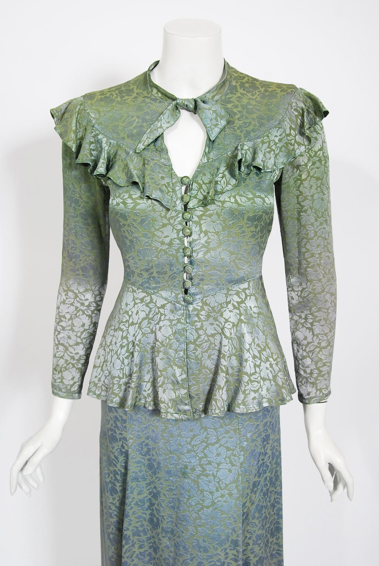 A totally gorgeous Ossie Clark for Radley blue green floral print damask satin peplum blouse with matching skirt dating back to the mid-1970's. English fashion designer, Raymond 
