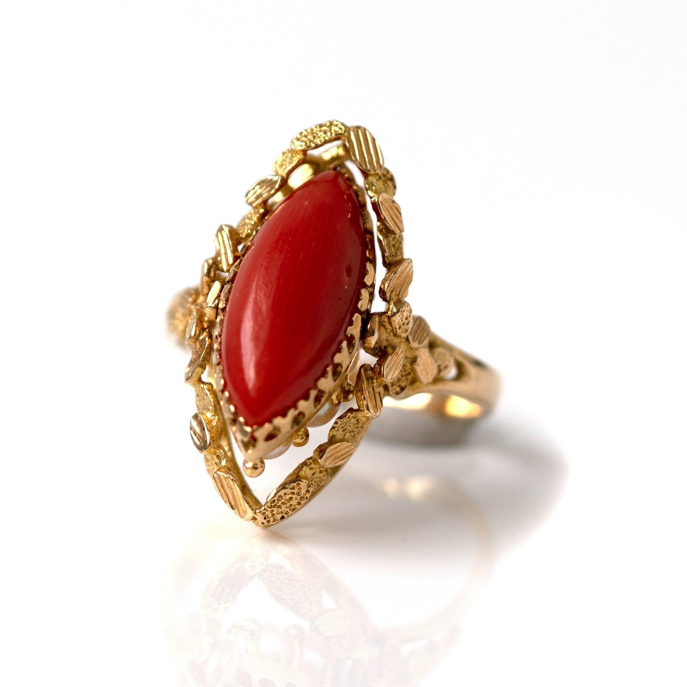Vintage 1970s Coral and Pearl reversible swivel ring. This unique piece is set in 18ct yellow gold with a secret swivel mechanism. One side of the ring is a marquise shaped Coral and the other side are claw set white pearls. The setting and band