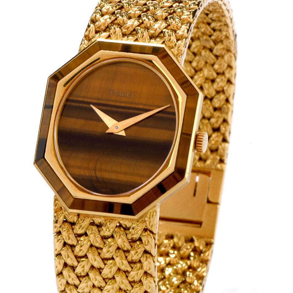 Bring the past back into the present with this gorgeous retro Vintage Piaget Tiger’s Eye 18K Yellow Gold Octagon 1970’s Women’s Watch! This classic collectible Piaget watch features a brown tiger’s eye dial, that catches each light beam to create a