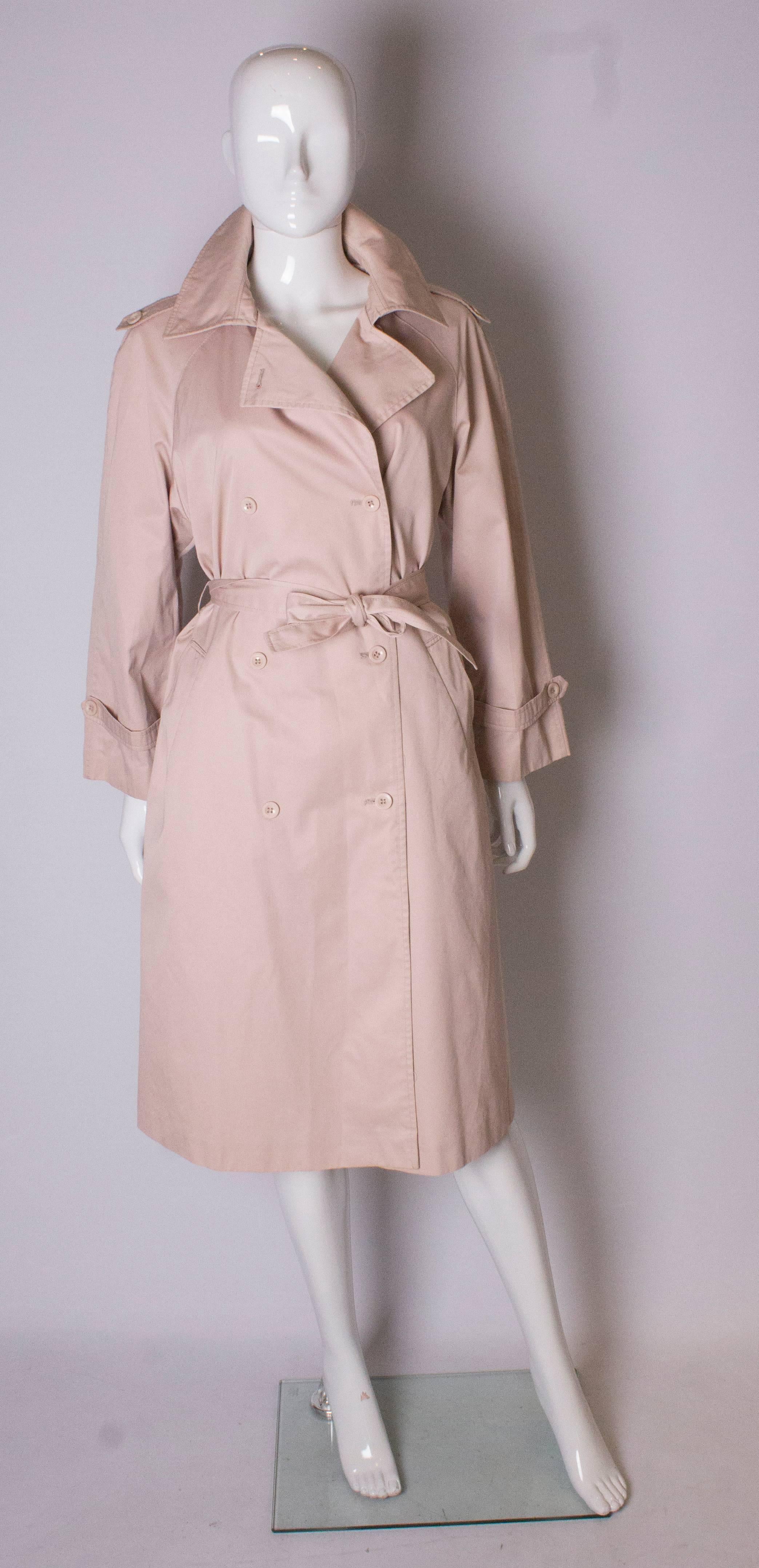A chic pink coat by Pierre Cardin.The coat has two pockets and a self fabric belt.