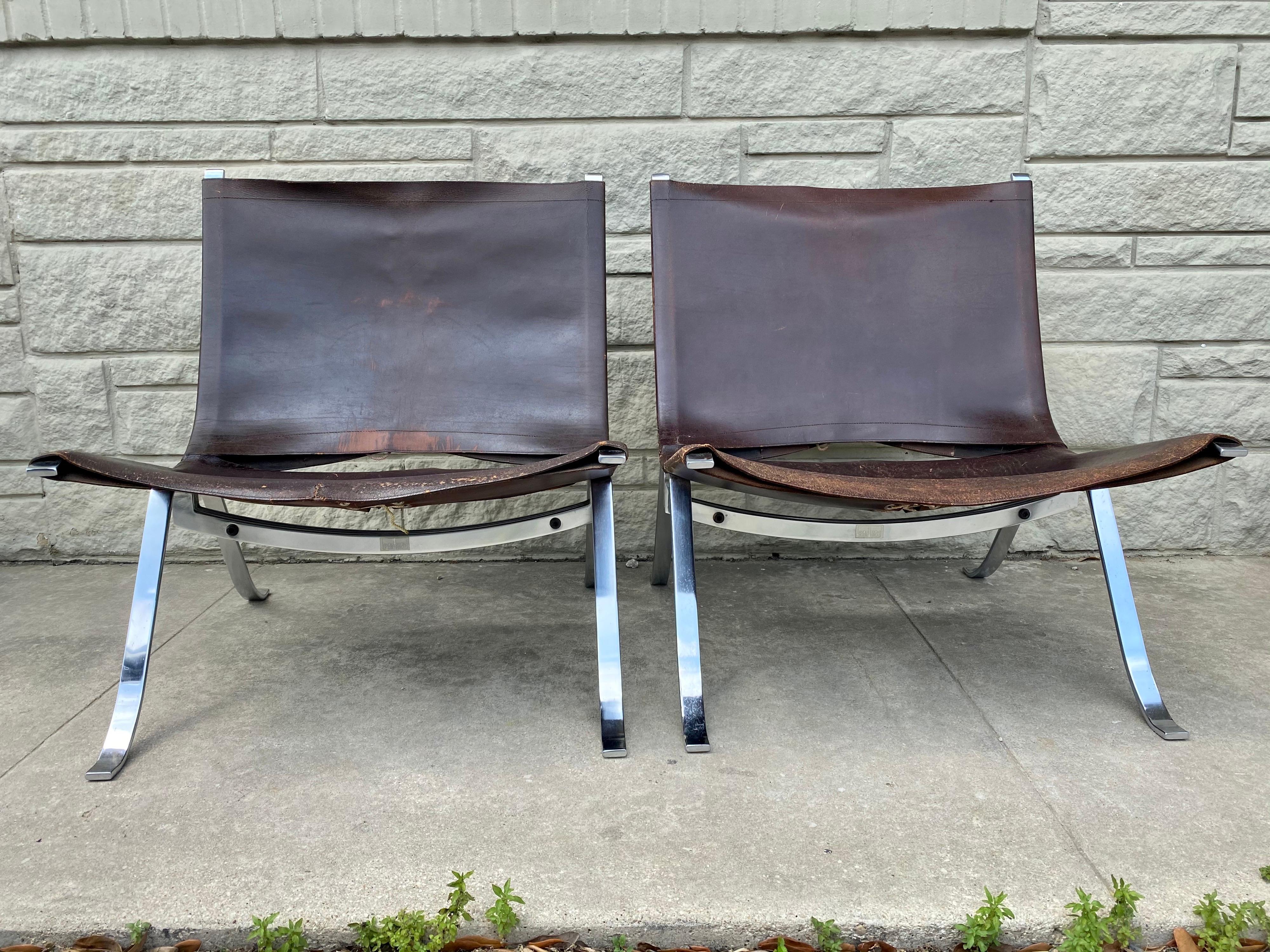 Designed by Preben Fabricius for Arnold Exclusiv, this unique pair is in overall good condition. Original leather. Distressed with scuffs, scratches, and discoloration, please refer to photos for condition. Small leather repair on one chair.