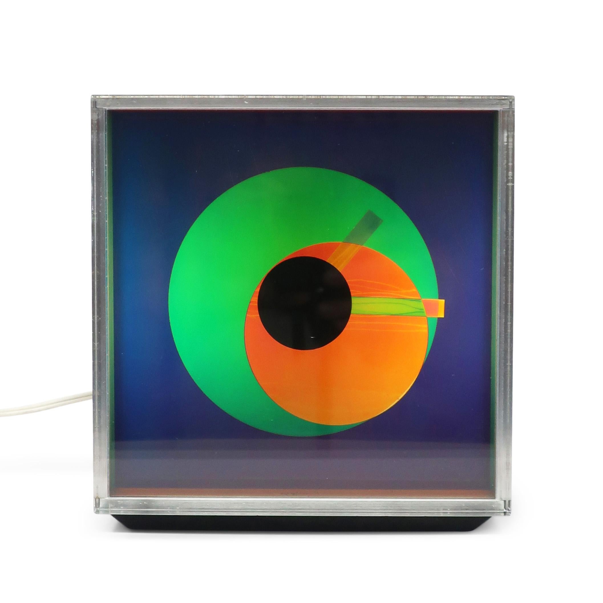 An op art inspired piece from 1976, the Prisma clock by Kirsch Hamilton Associates manages to capture vibrant colors, minimalism, and 1970s space age design.  This mysterious color changing clock has a chrome body, thick lucite lens over laminated