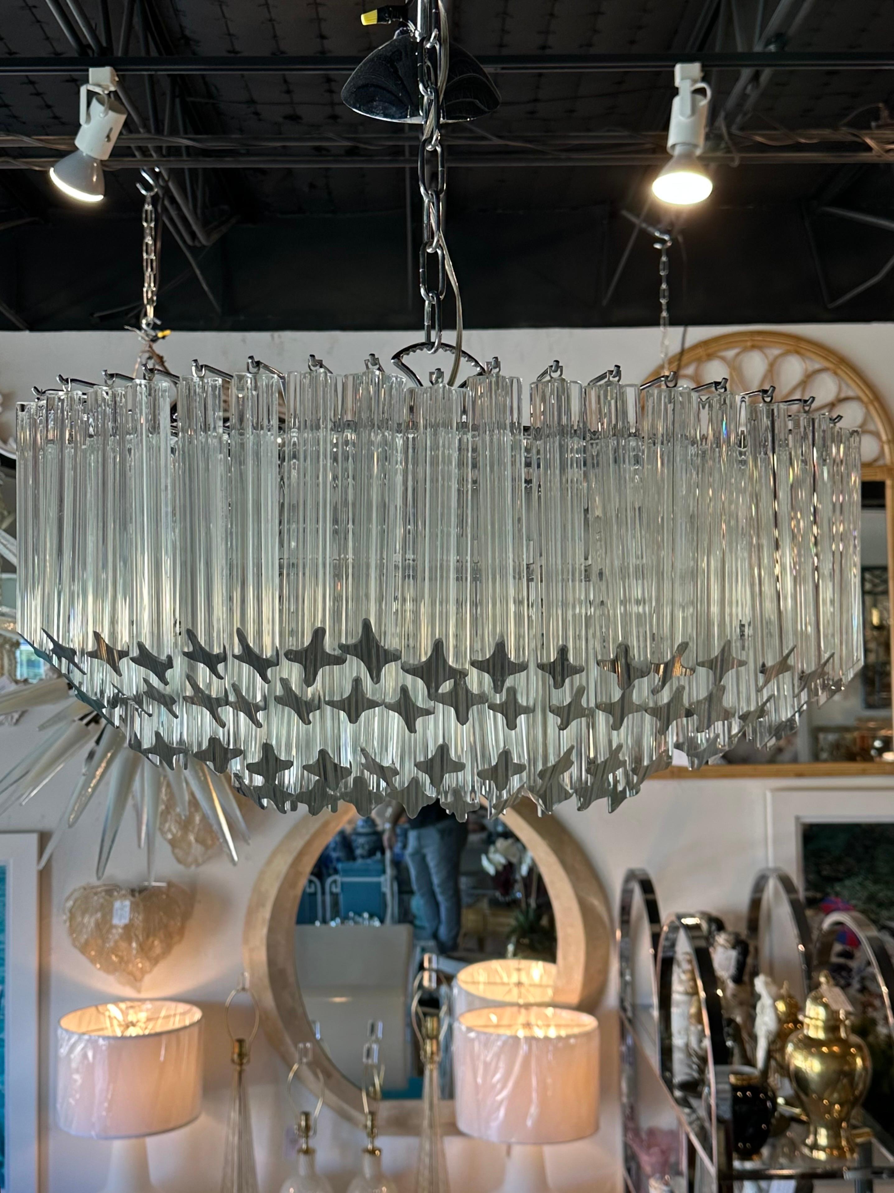 Vintage 1970s Camer Murano Quatrefoil (4 sided glass), 4 tier chandelier. Chrome cage and original ceiling canopy. Holds 4 large size light bulbs. No chips or breaks to any of the glass pieces. Dimensions which do not include the chain length,