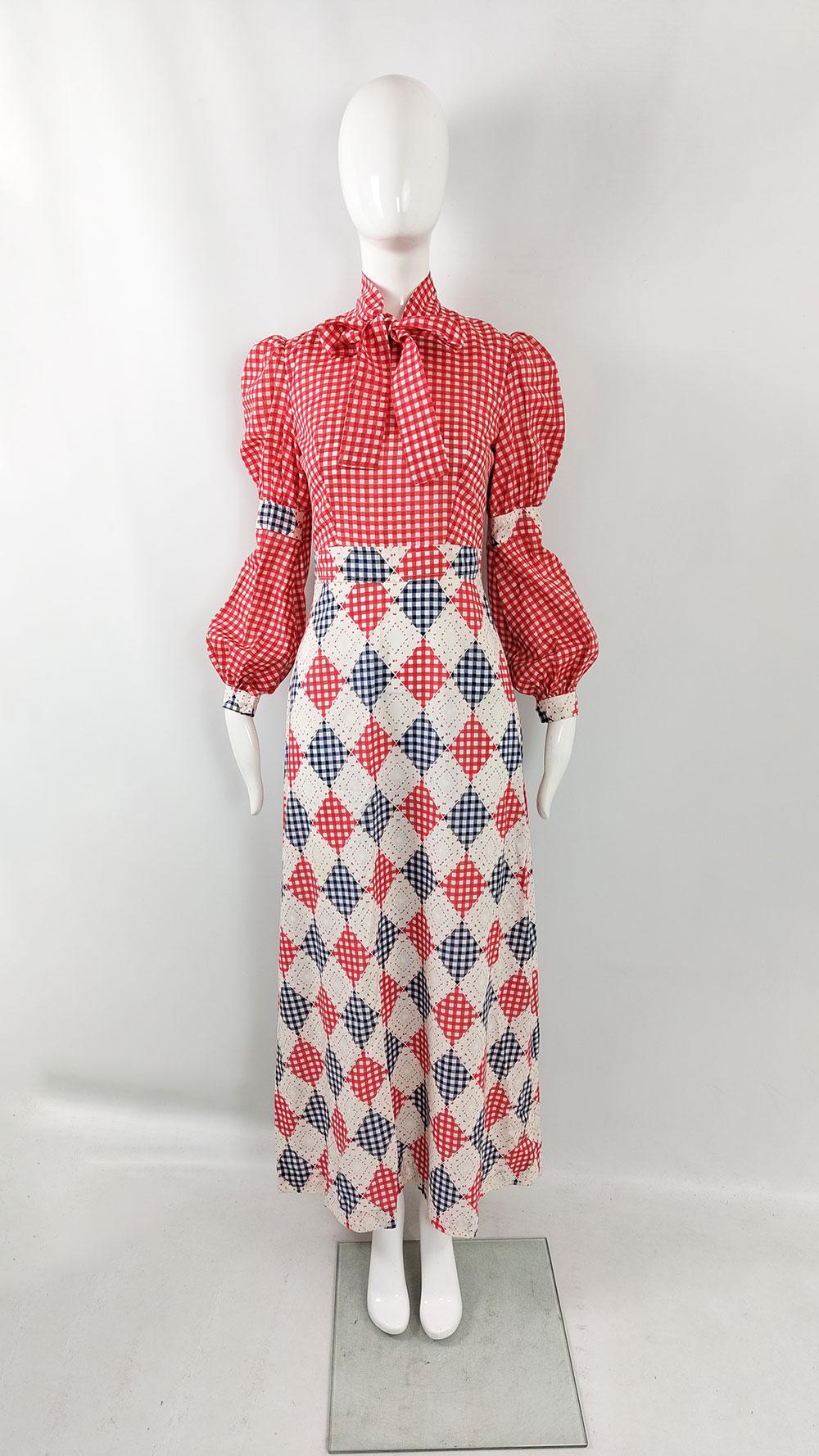 A stunning vintage women's maxi dress from the 1970s by the British boutique label St Andre. The top showcases a red and white gingham check fabric, while the skirt features a diamond print. The standout feature is the marvelous bishop-style