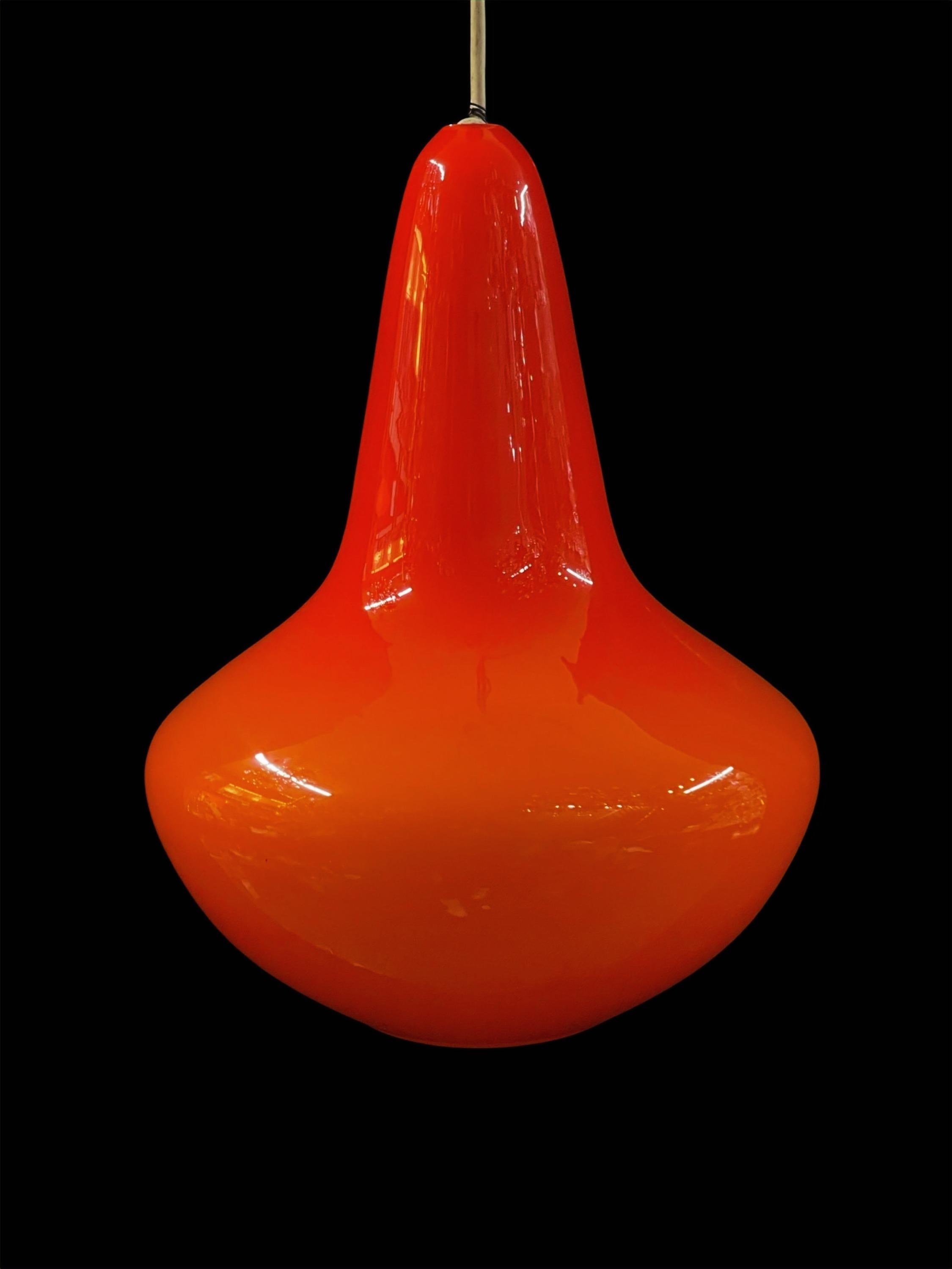 Introducing our stunning Vintage Bold Orange Glass Pendant Light, a timeless piece reminiscent of the vibrant 1970s era.

Radiating a rich, luminous orange hue, this pendant light is not only in impeccable condition but also serves as a captivating