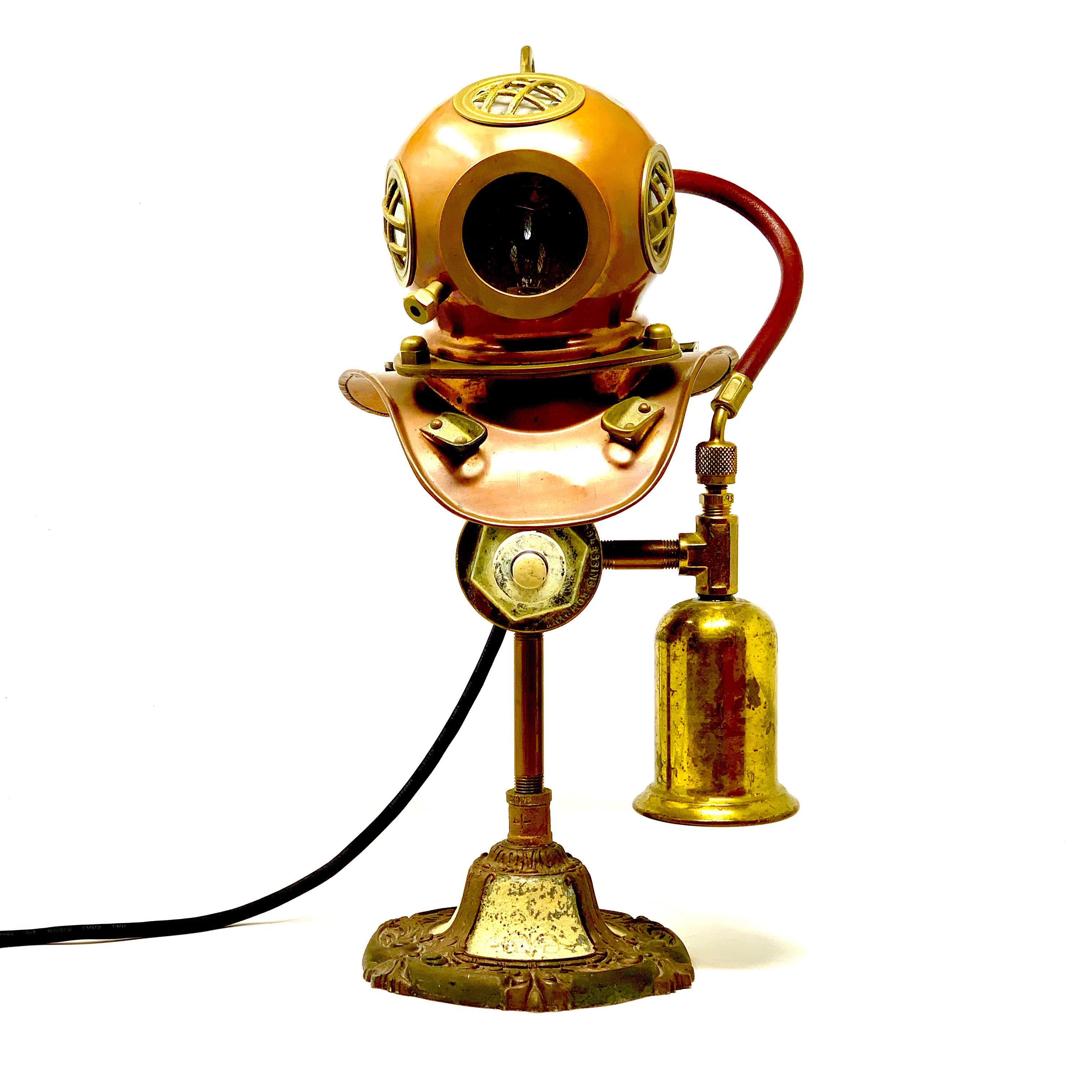 Vintage steampunk lamp made from a 1970s Rolex brass diving helmet display, with a vintage iron base and unique details. A very unique piece, in excellent vintage condition.

Width: 10 in / Depth: 7 in / Height: 16.75 in