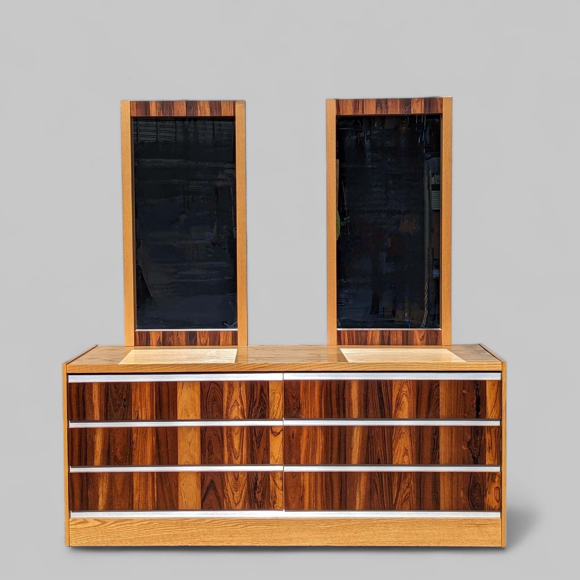 This Vintage 1970s Rosewood and Oak Dresser with Chrome Accents is a stunning piece of mid-century modern furniture, made in Canada. 

Crafted from rich rosewood and oak veneer, this dresser features sleek chrome accents that highlight its