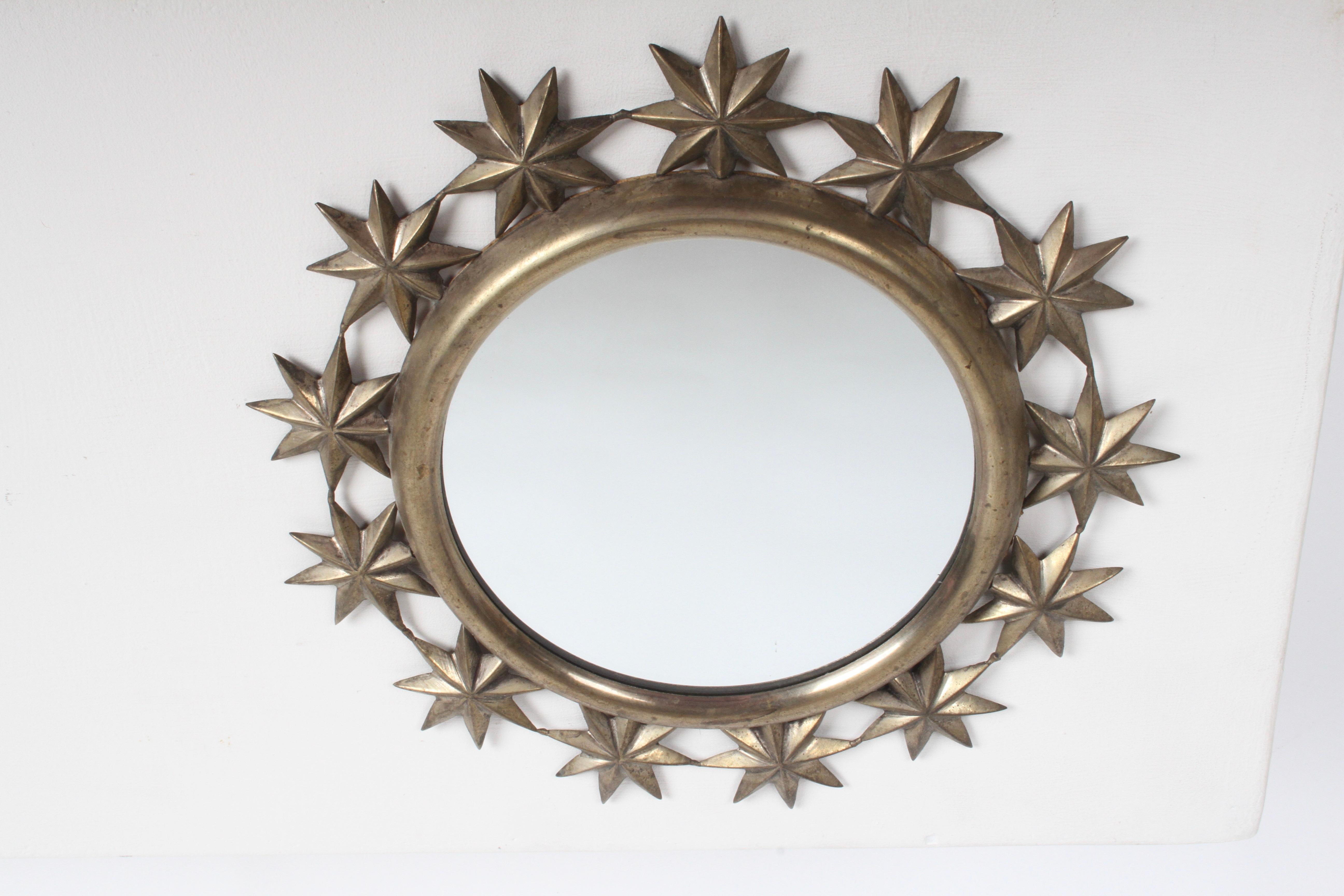 Vintage Hollywood Regency Saaried round brass mirror with 13 repousse Stars around brass frame. Brass has warm patina, light loss to mirror backing. Label on verso.