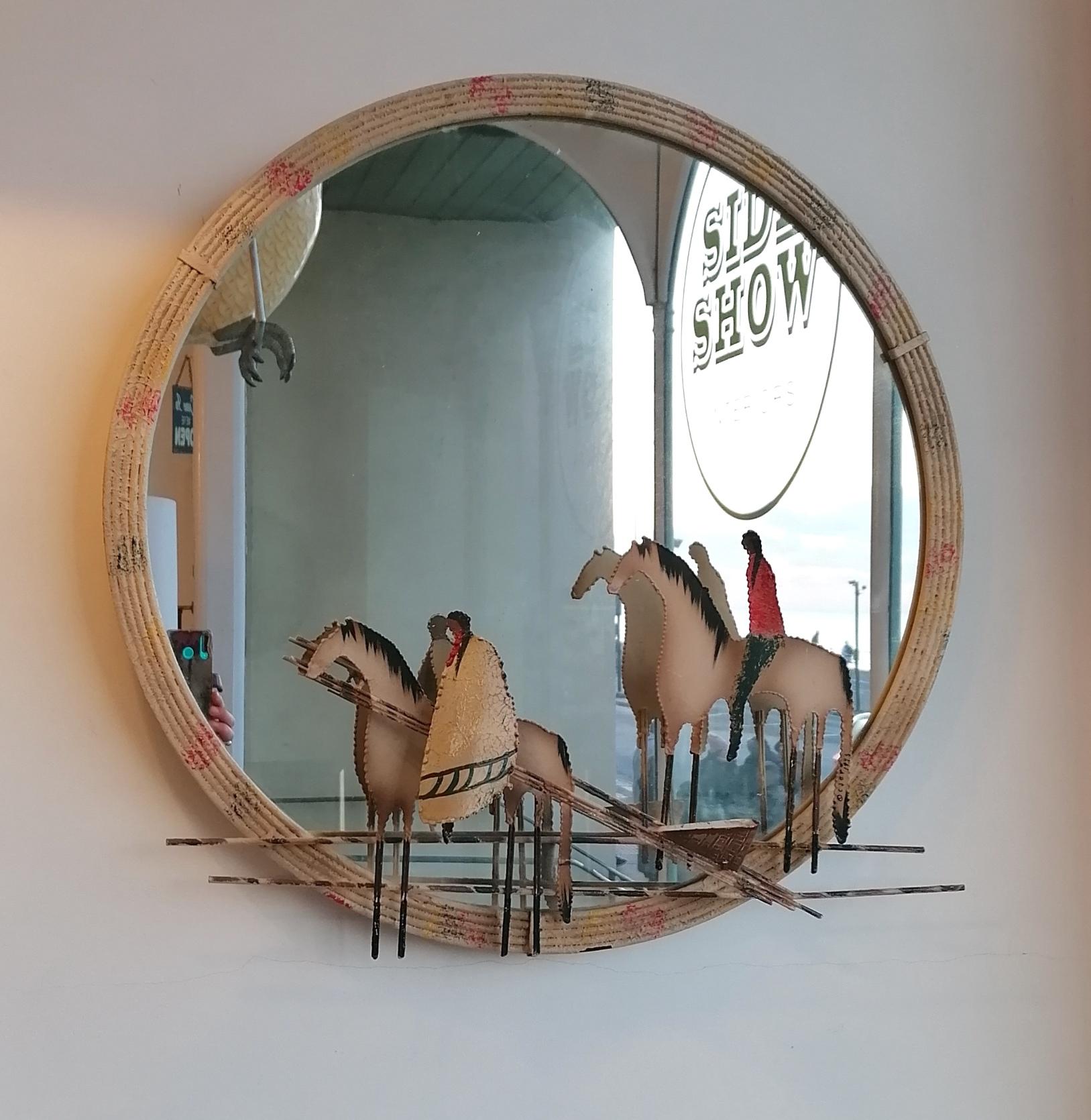 A really unusual 1970s Curtis Jere mirror (signed). Painted torch-cut metal scene of Native American horseback riders. Painted iron or steel frame & back. Has a lovely Folk Art look.

Dimensions: width 70cm, height 70cm, depth 13cm.