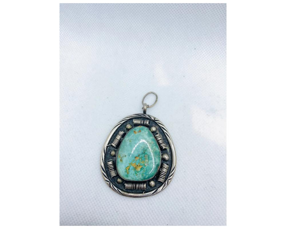 Rare Vintage Native American Turquoise Pendant Signed navajo 
Large and in great condition some minor wear consistant with age and use 
the size is approximately 2 ½ inches from top to bottom of the pendant and approximately 2 inches wide 
the