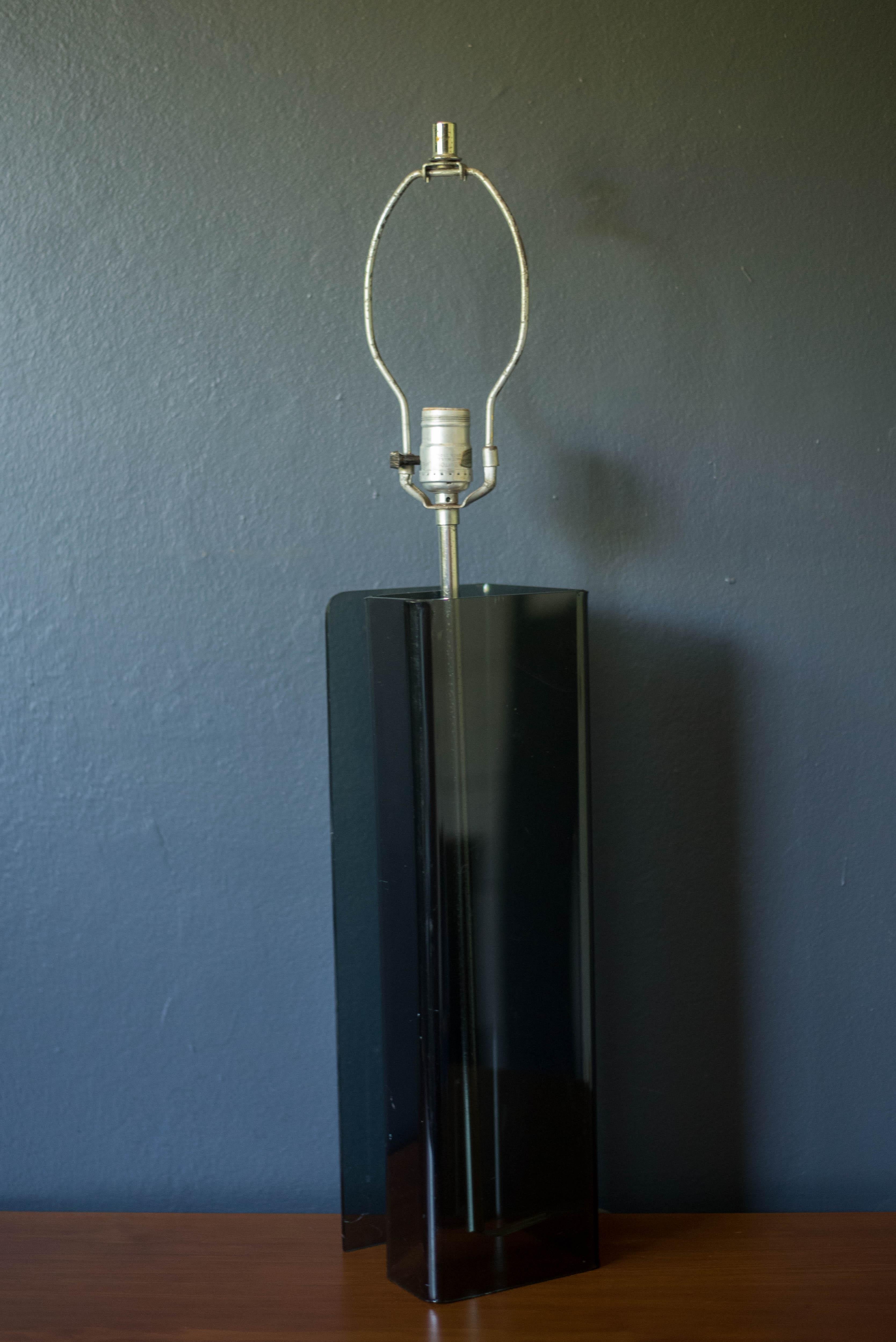 Mid-Century Modern Space Age accent table lamp circa 1970s. Features a tall smoked acrylic base with a floating aluminum center rod. Lamp shade is not included.

.