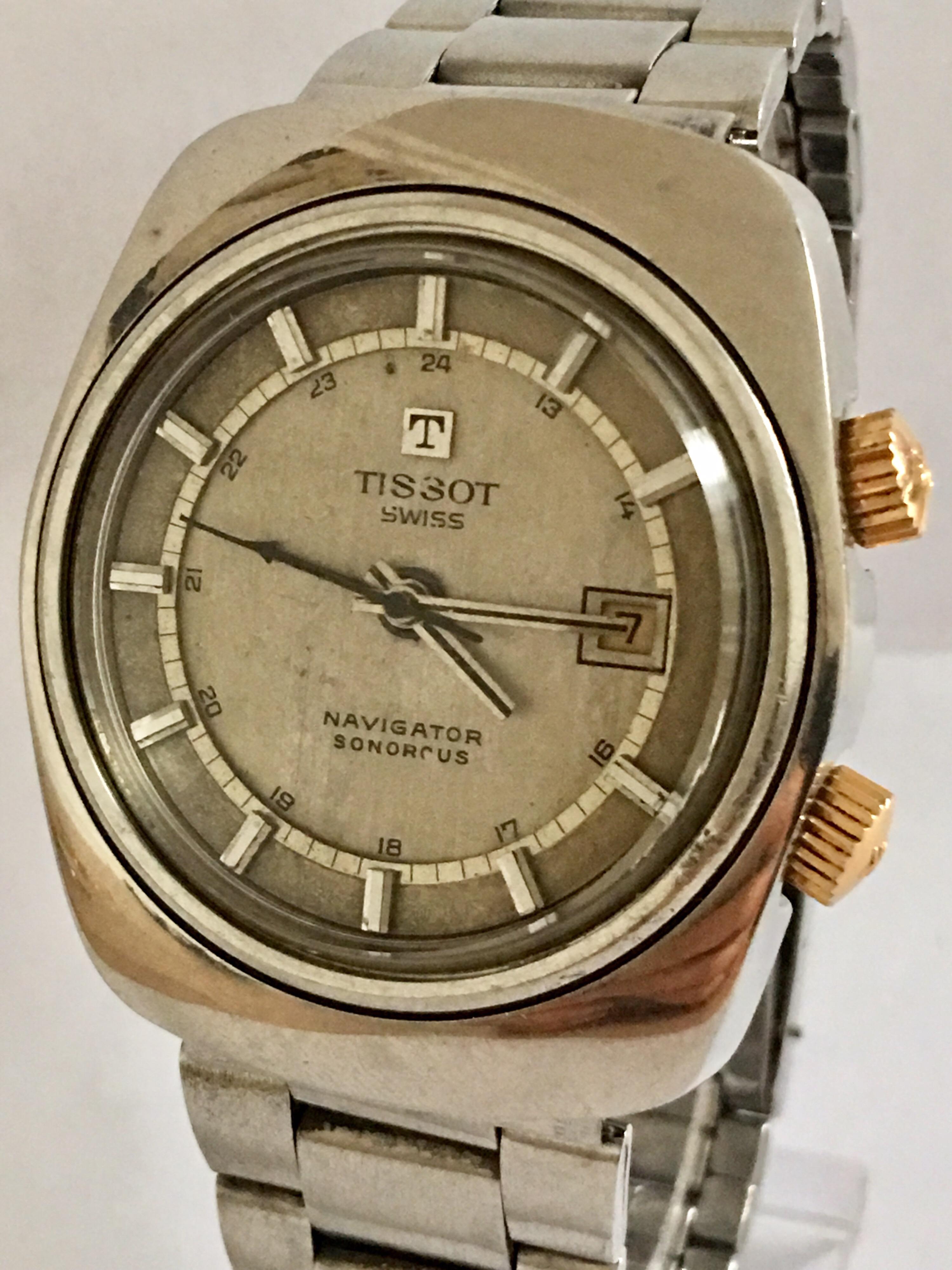 This Rare Vintage 37mm wide and 44mm long cushion shaped, 33mm face diameter mechanical Alarm watch is in good Working condition and is running well. Visible signs of ageing and wear with light surface marks on the glass, watch strap and on the