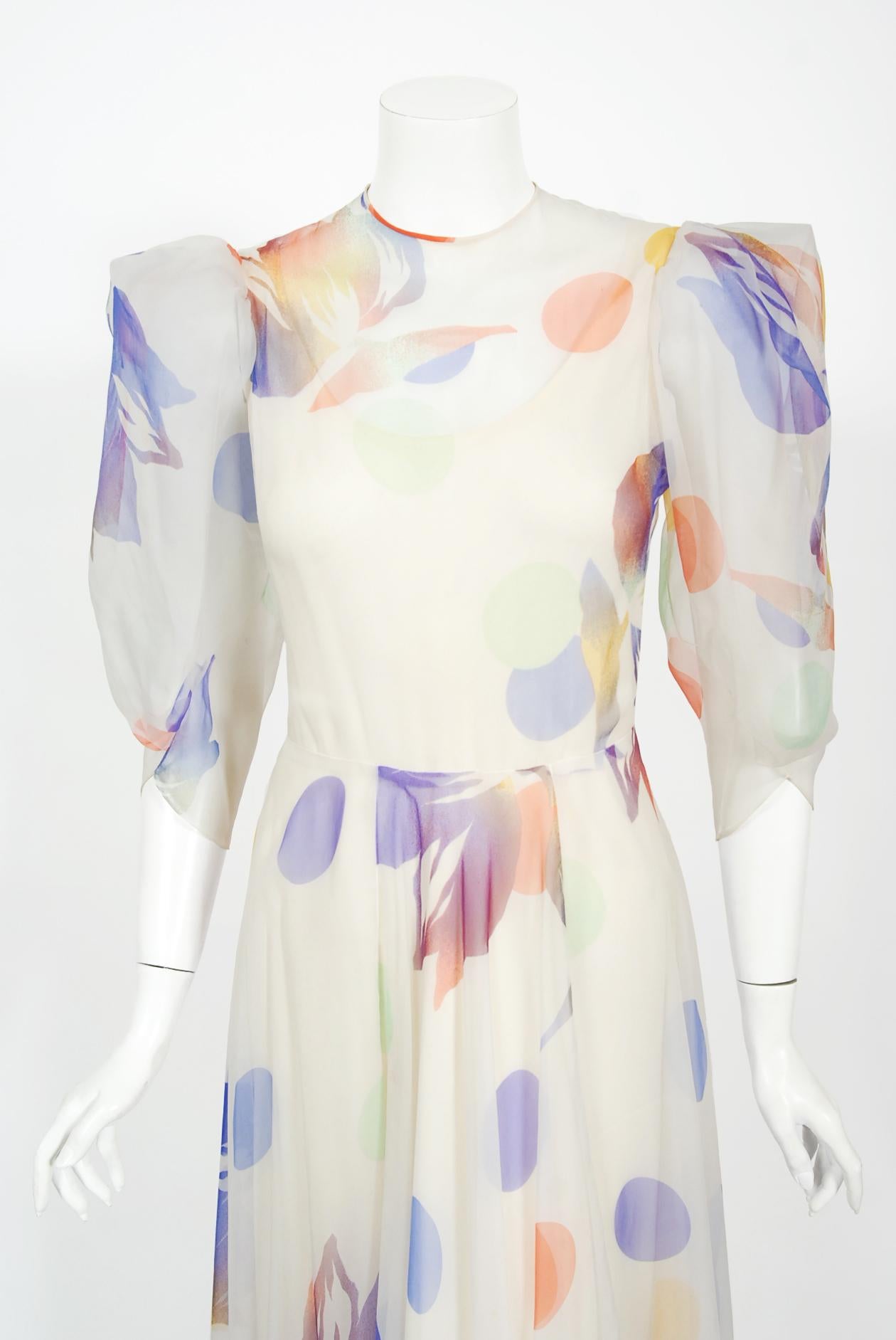 A magical rainbow watercolor dotted floral print silk chiffon Stavropoulos Couture gown dating back to the late 1970's. George Stavropoulos was a New York fashion designer best known for his innovatively draped dresses and evening gowns that seemed