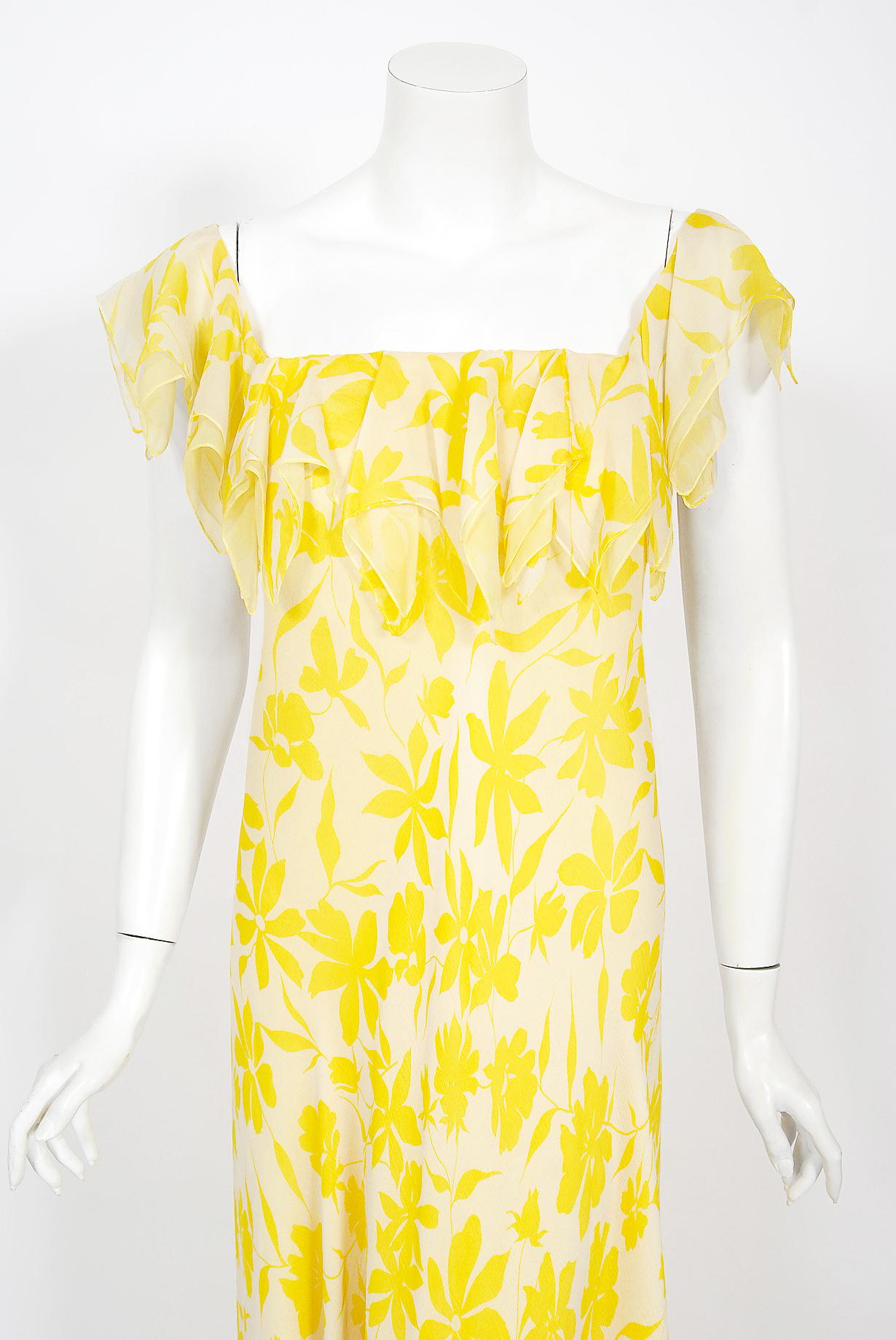 An ethereal yellow and white floral print silk chiffon Stavropoulos Couture bias-cut gown dating back to the mid 1970's. George Stavropoulos was a New York fashion designer best known for his innovatively draped dresses and evening gowns that seemed