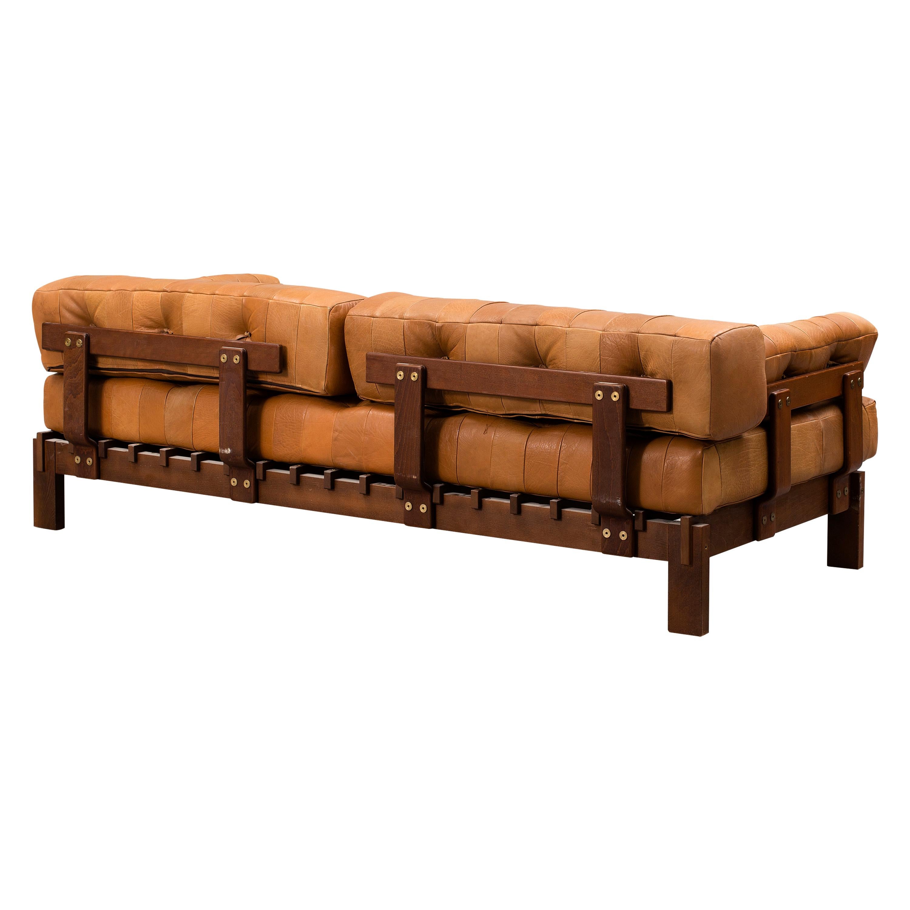 1970s vintage deep-seated sofa with its original smooth leather upholstery. In the style of De Sede - Model DS-80. The leather patchwork has slightly different tones all over with high quality stitching. The leather is in really good condition,
