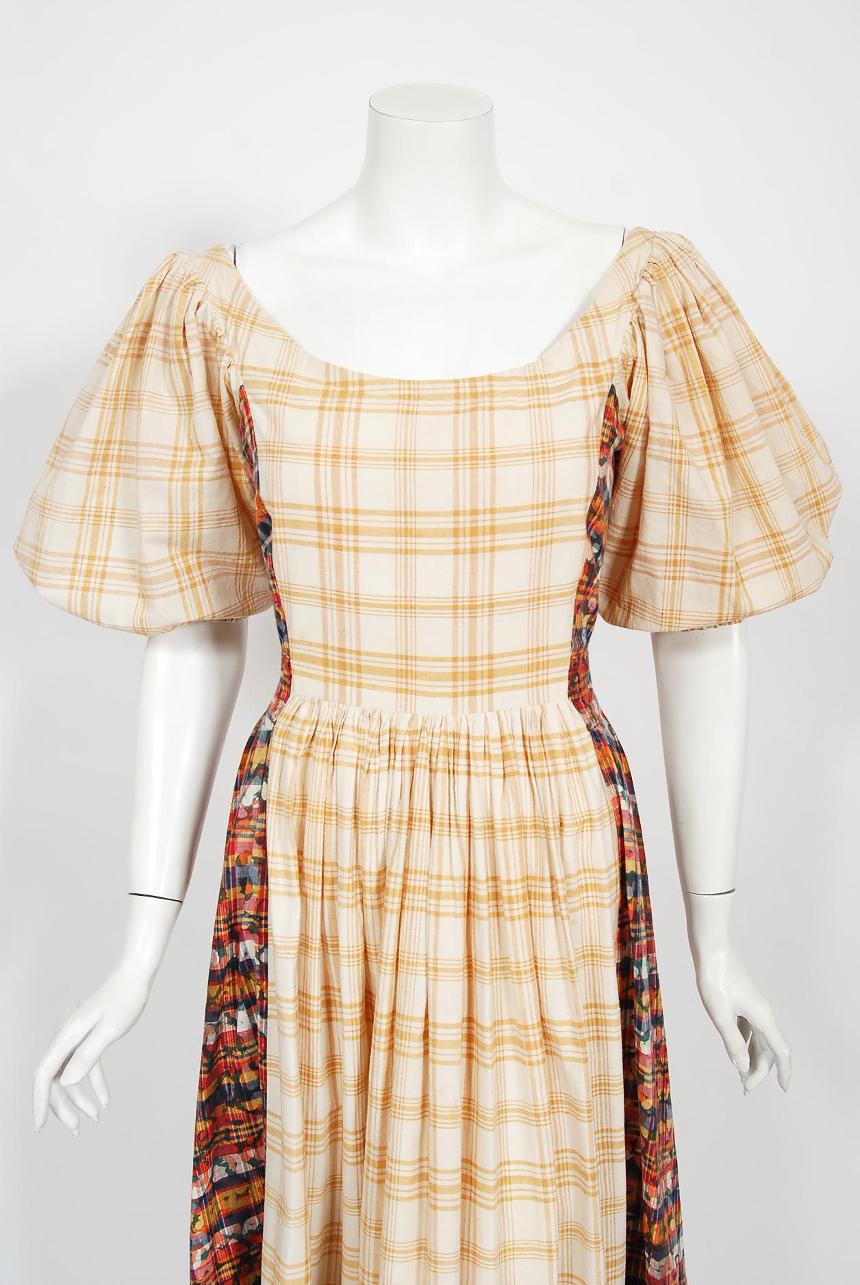 A Gorgeous early 1970's Thea Porter couture maxi dress fashioned in a luxurious marigold ivory plaid cotton with magical tie dyed accents. The stunning fabric is trimmed in metallic gold that has a touch of shimmer which I adore. The bodice has a