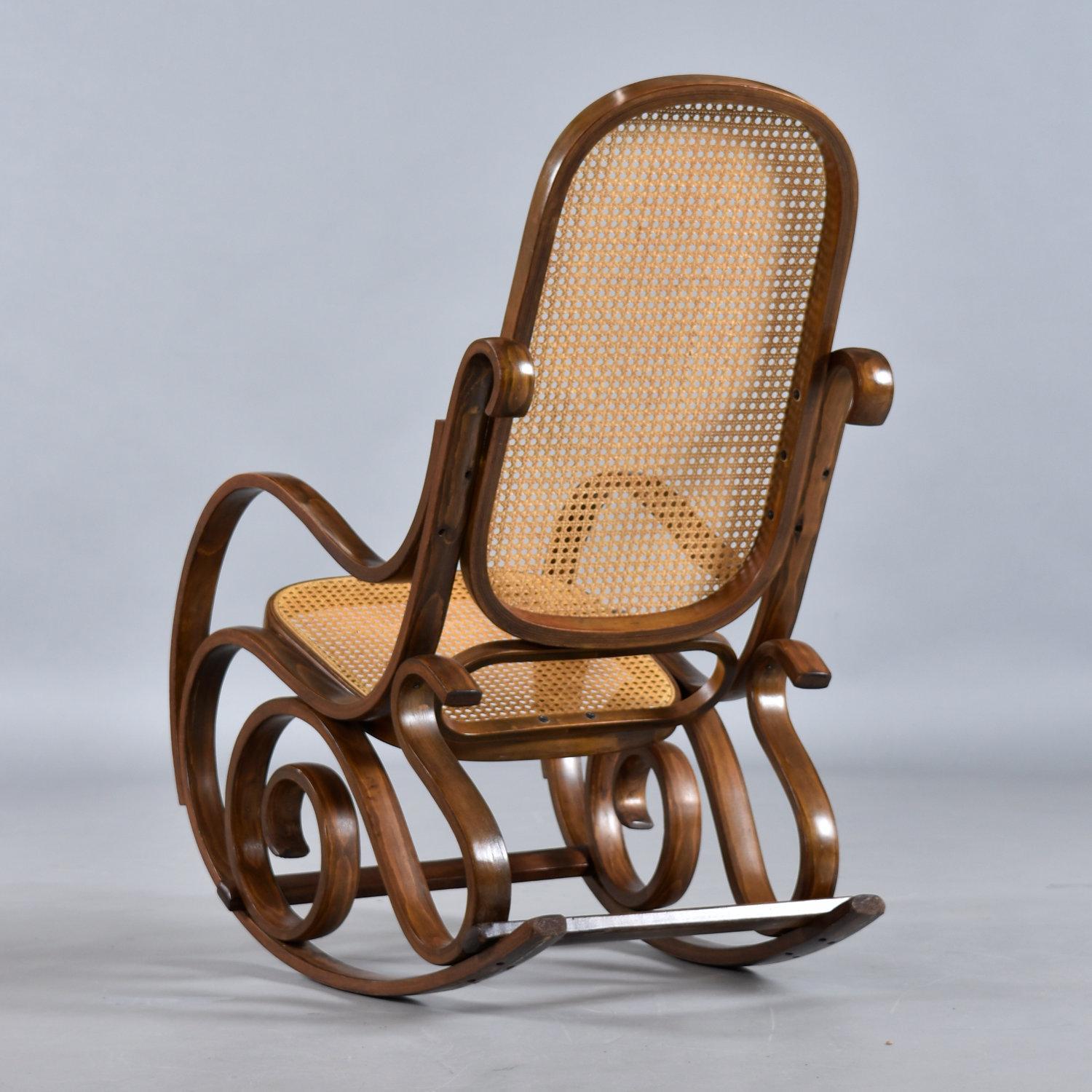 1970's rocking chair ideal for a nursery, family room or home office. The frame is beautifully contoured wood, designed similarly to Thonet’s No. 21 chair. The seat and back rest are woven cane.

21” Wide x 35” Deep x 39.5” High (18.5” seat