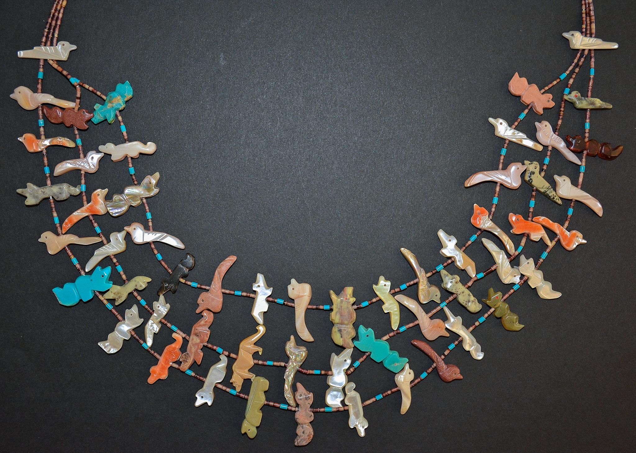 Un exemple exceptionnel de collier fétiche à trois brins de Zuni datant des années 1970. Le collier est piqué de perles de coquillages Heishi et de fétiches sculptés.  en turquoise, huître creuse, ambre, nacre, pierre à fusil, 
Abalone Shell,