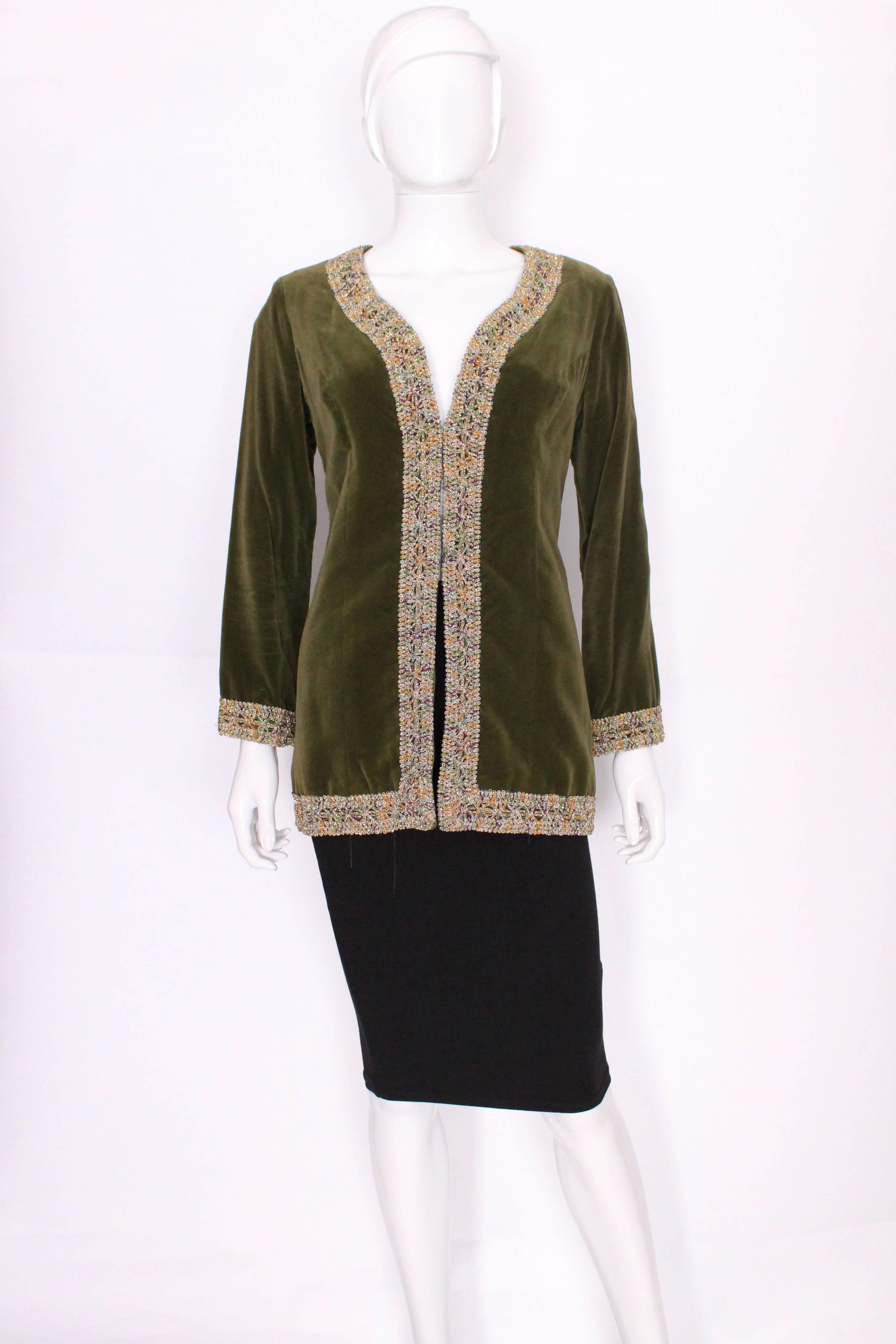A groovy vintage jacket from the 1970s, by British firm Quad In a super soft sage green velvet, this jacket is edged in a  colourful braid . The body of the jacket is fully lined.