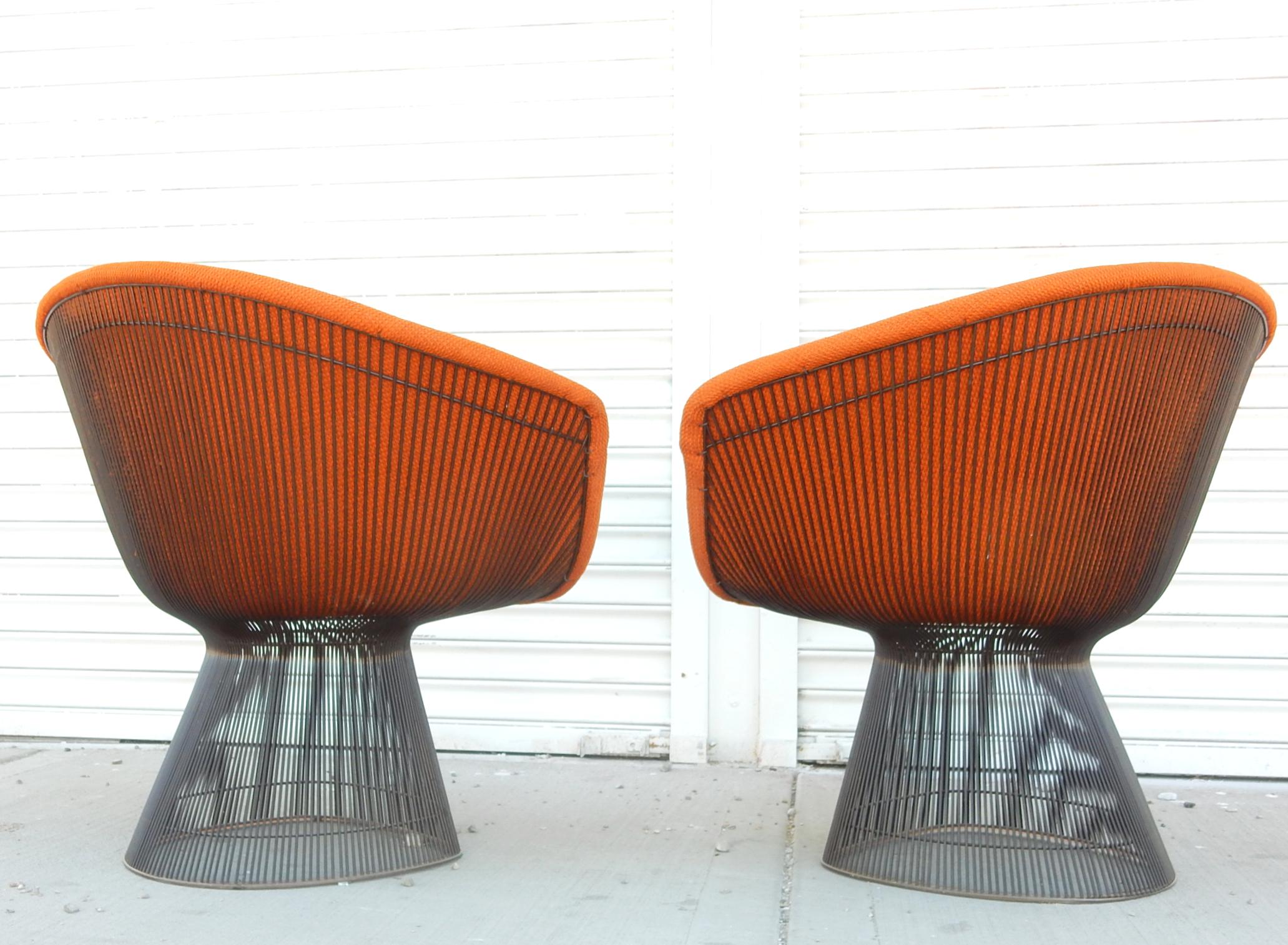 Extraordinary pair of the iconic wire lounge chair designed by Warren Platner for Knoll International., dated 1978.
Original Knoll orange upholstery on anodized black wire frames. Both labelled under seat cushion.
These chairs are clean and show