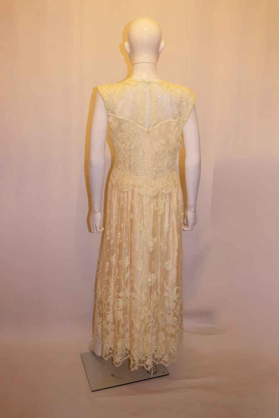A pretty vintage lace gown, ideal for a party or wedding. The dress is easy to wear with contrasting upper and  skirt areas. The dress is fully lined . Bust up to 37'', length 58''