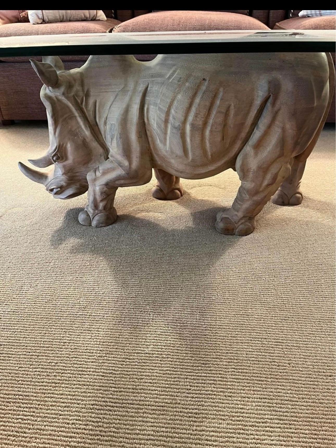 Wonderful vintage solid wood carved rhino rhinoceros coffee cocktail table. Original natural wood finish. May have natural fine cracks to wood. No damage or breaks. Glass shown does not come with table since its vintage and has scratches. It is