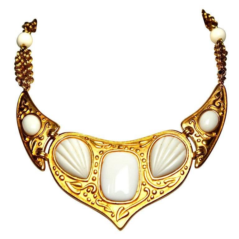 Dramatic, gilt metal necklace with faux ivory resin stones from Yves Saint Laurent dating to the late 1970's, early 1980's. Necklace measures approximately 16