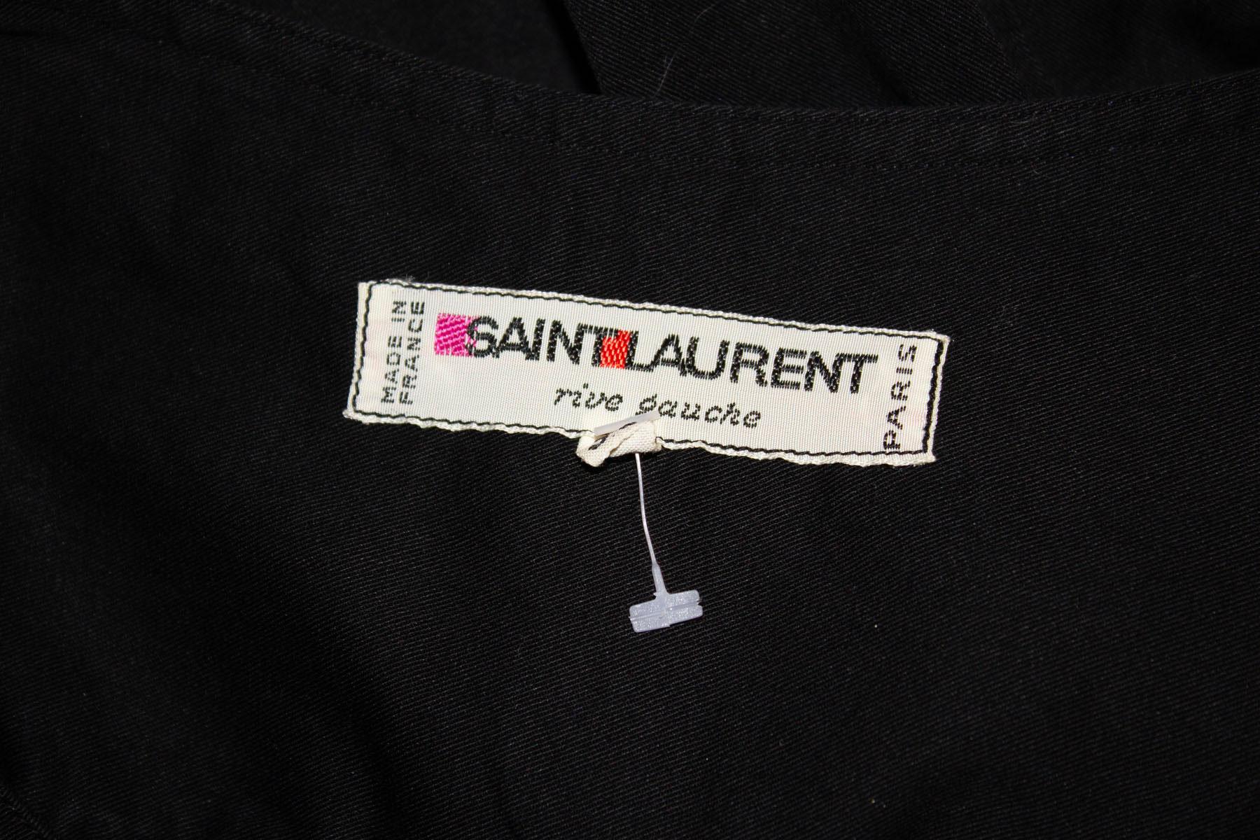 A chic and easy to wear vintage cotton top , by Yves Saint Laurent Rive Gauche. 
In black cotton the top has a round neckline with gathering, elasticated sleaves and a pocket on either side.  Size 38, Measurements Bust up to 42'', length 31''